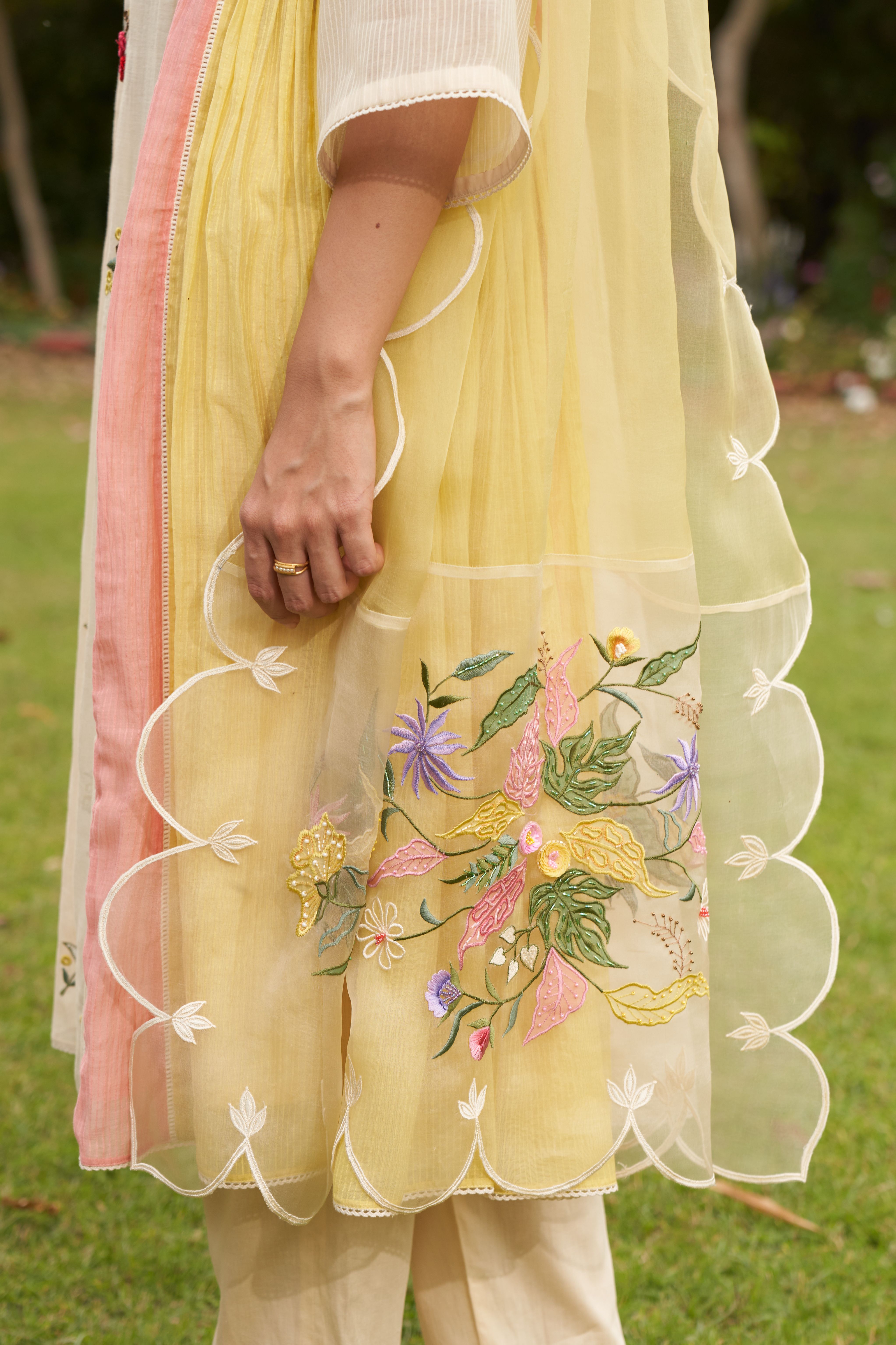A model showcasing Lemon Beige Embroiderd Color Block Organza Dupatta by Nirvair from Nirvair's collection A model showcasing Lemon Beige Embroiderd Color Block Organza Dupatta by Nirvair from Nirvair's collection