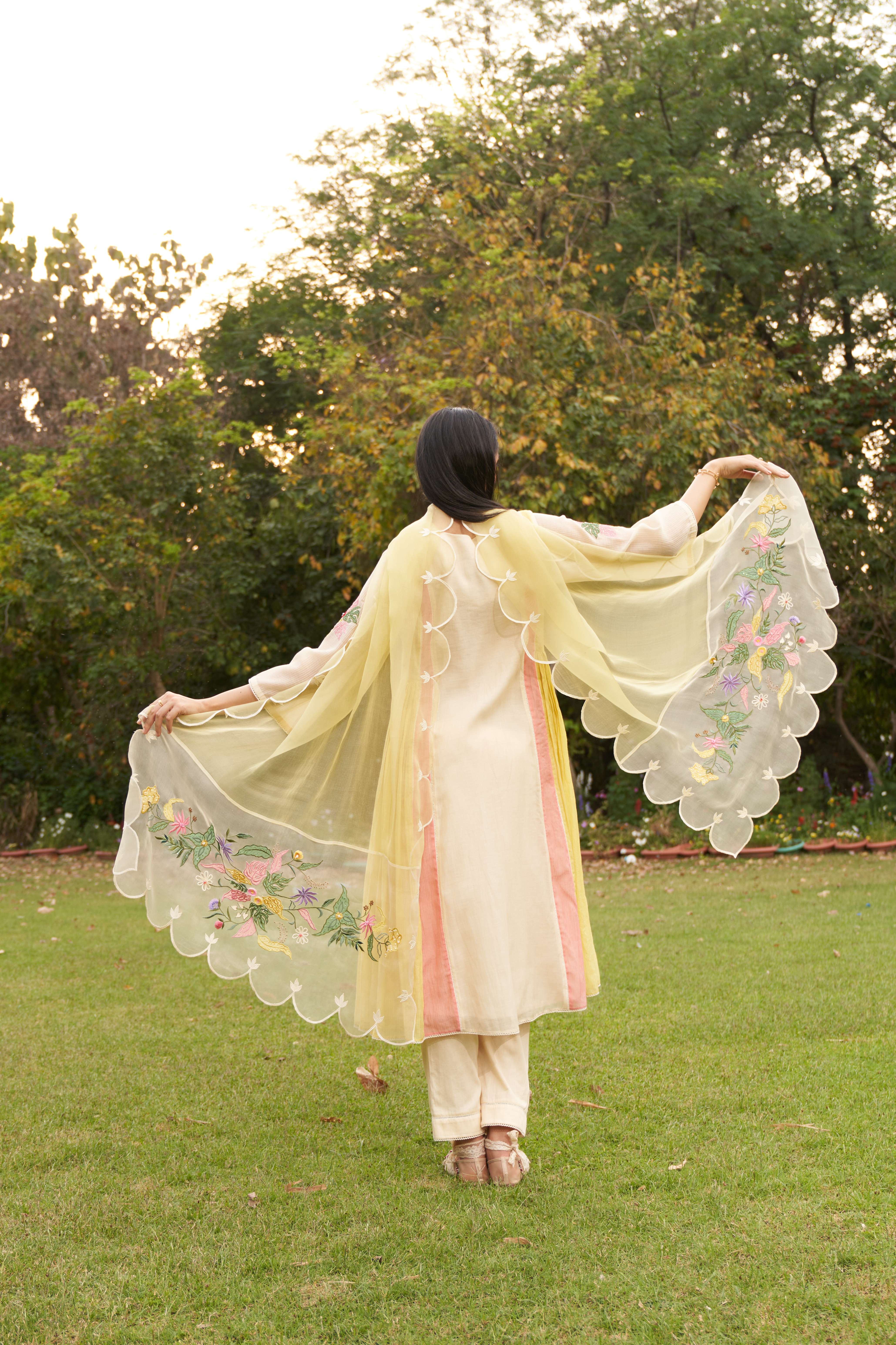 A model showcasing Lemon Beige Embroiderd Color Block Organza Dupatta by Nirvair from Nirvair's collection A model showcasing Lemon Beige Embroiderd Color Block Organza Dupatta by Nirvair from Nirvair's collection