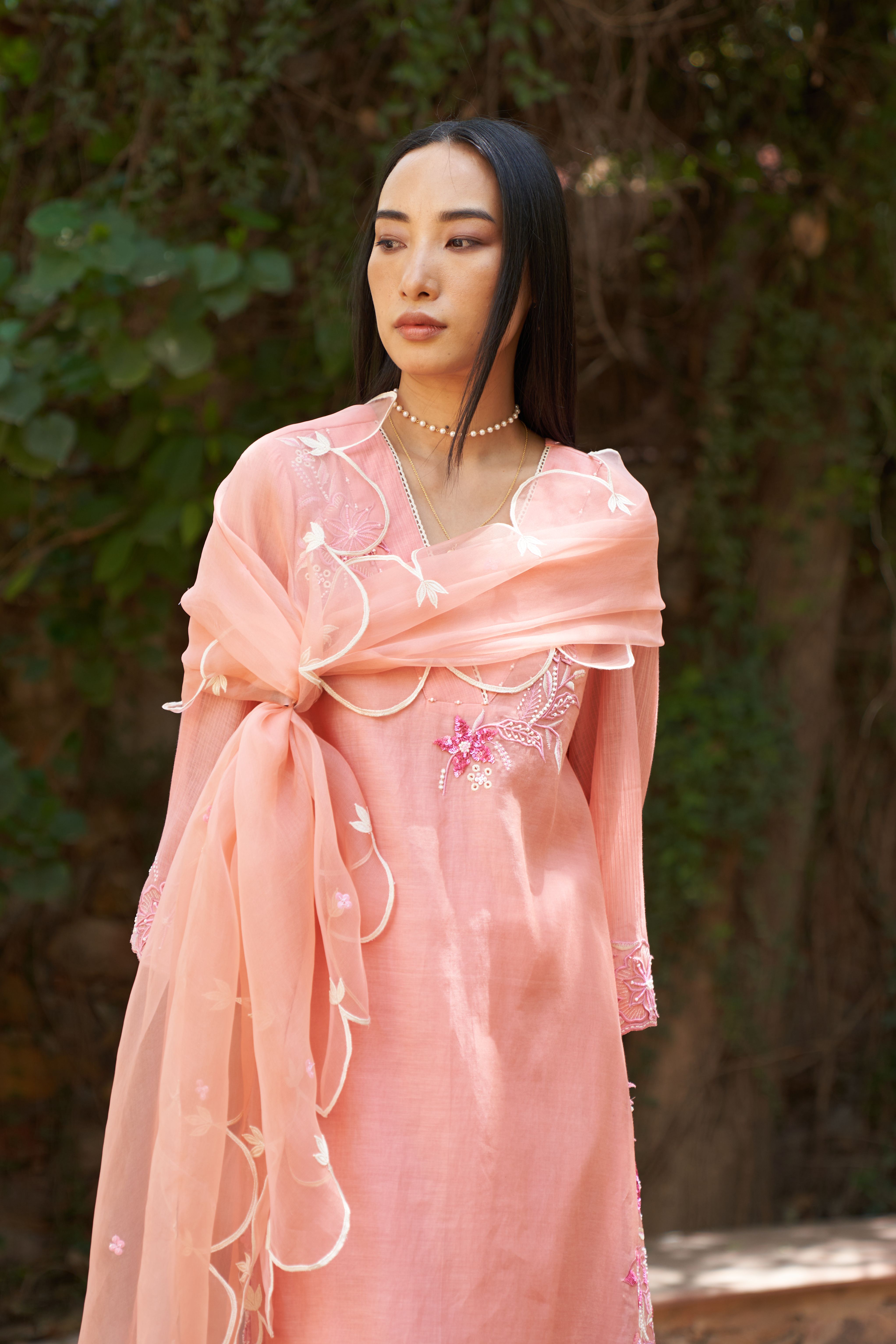 A model showcasing Azalea Peach Organza Dupatta by Nirvair from Nirvair's collection