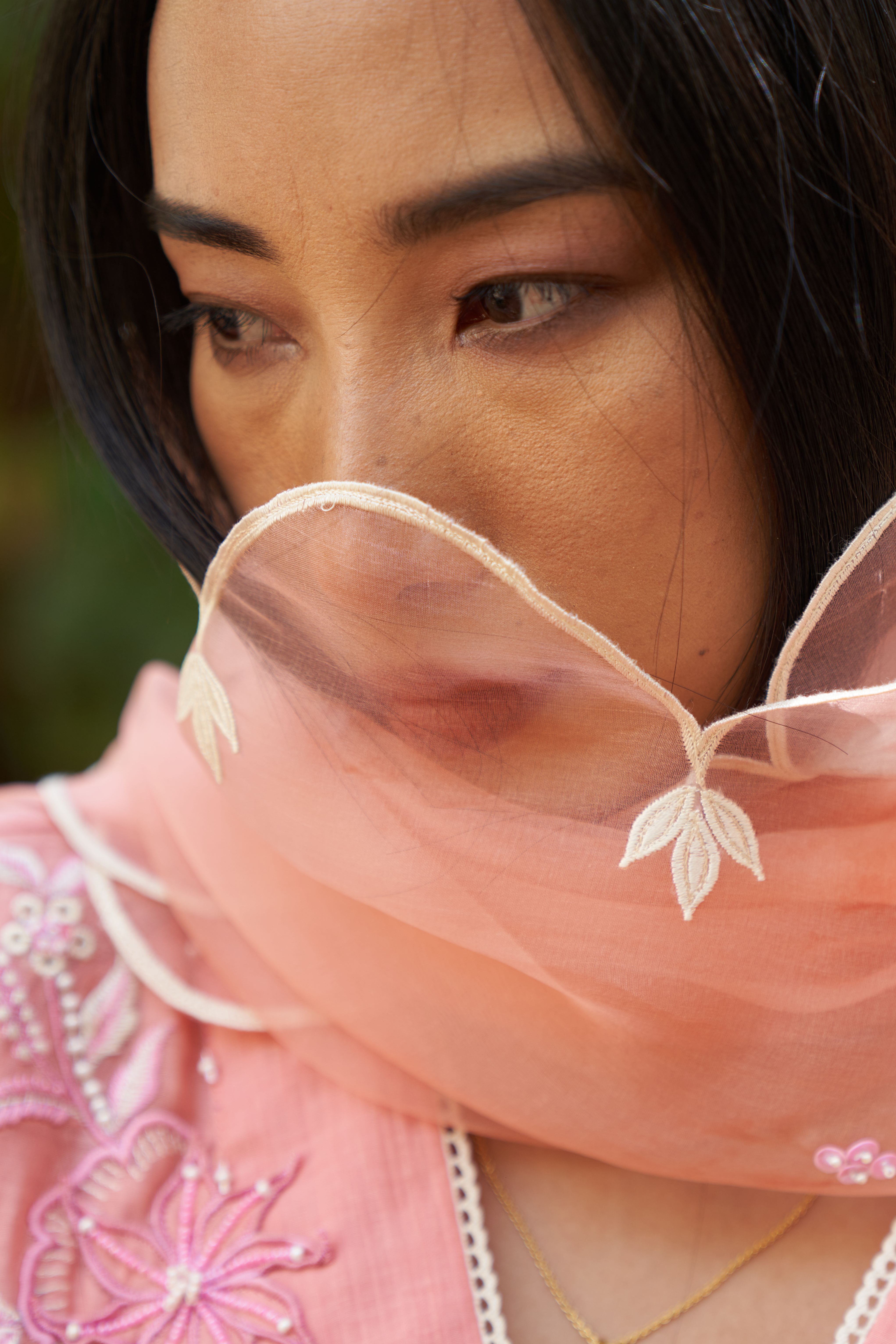 A model showcasing Azalea Peach Organza Dupatta by Nirvair from Nirvair's collection A model showcasing Azalea Peach Organza Dupatta by Nirvair from Nirvair's collection