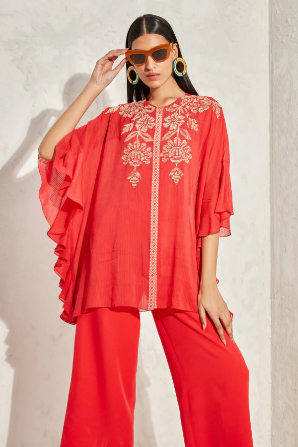 A model showcasing Forsythia Frill Sleeve Kaftan Top by Namrata Joshlpura from Namrata Joshlpura's collection A model showcasing Forsythia Frill Sleeve Kaftan Top by Namrata Joshlpura from Namrata Joshlpura's collection