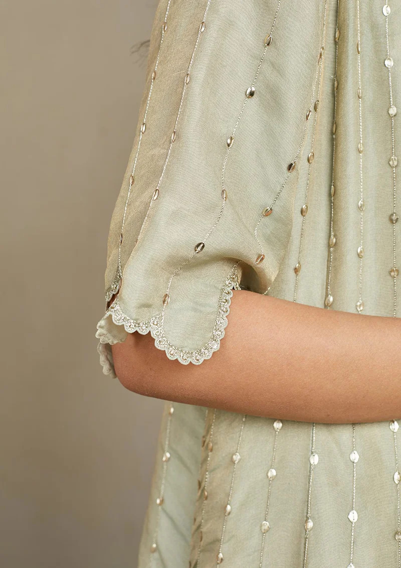A model showcasing Ivory Optical Embroidered Jacket Lehenga Set by Ossa from Ossa's collection A model showcasing Ivory Optical Embroidered Jacket Lehenga Set by Ossa from Ossa's collection