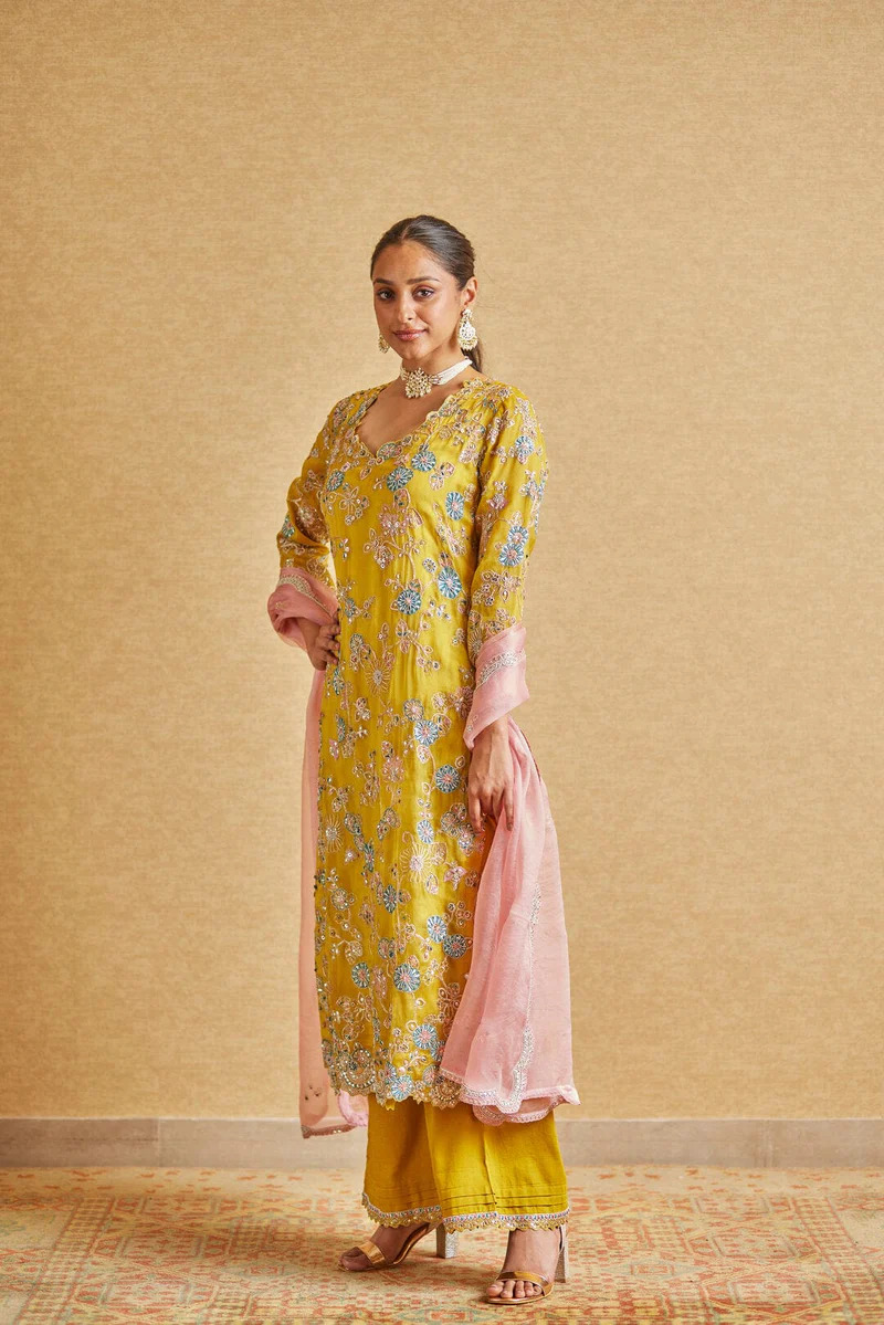 A model showcasing Honey Gold Embroidered Suit by Ossa from Ossa's collection A model showcasing Honey Gold Embroidered Suit by Ossa from Ossa's collection