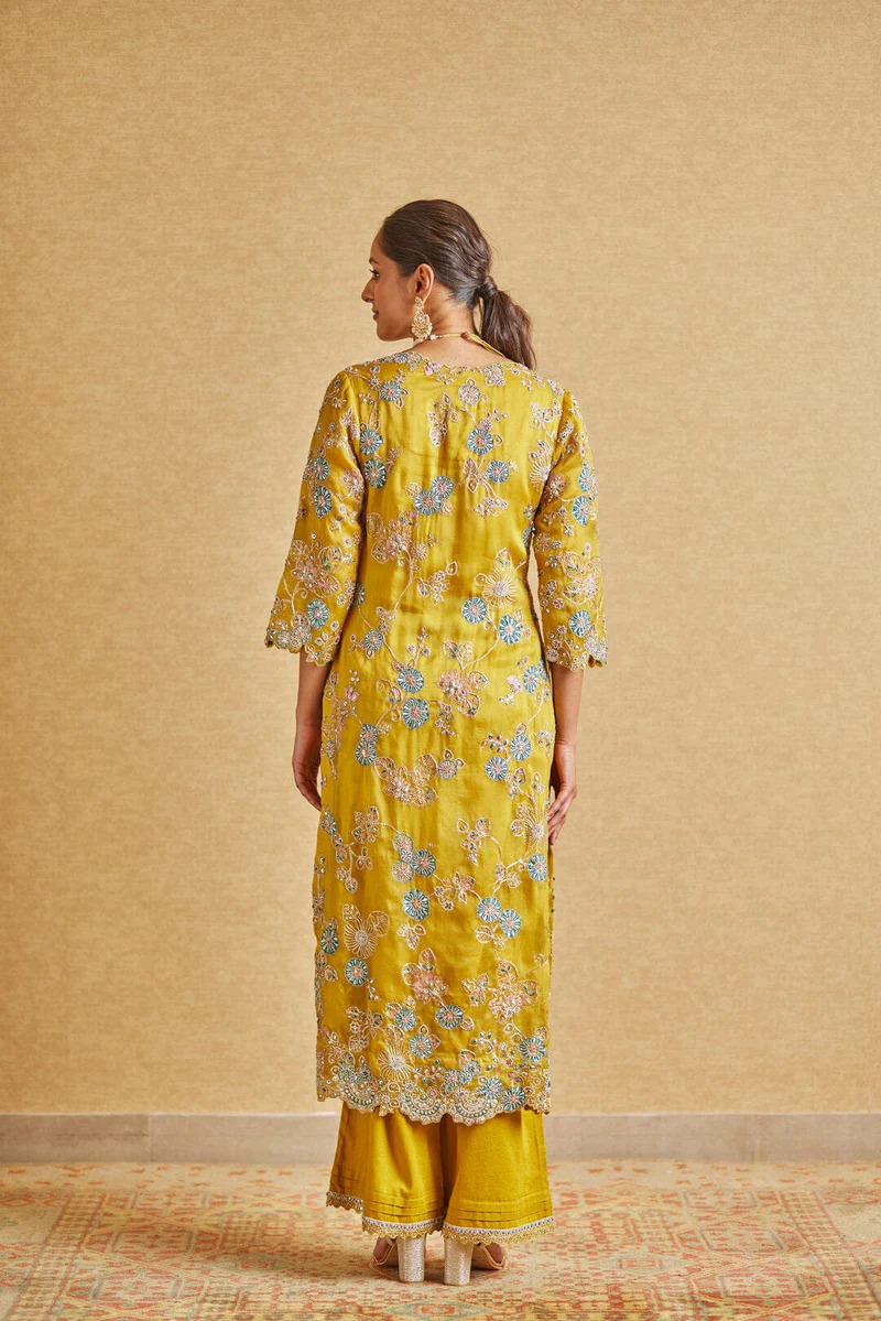 A model showcasing Honey Gold Embroidered Suit by Ossa from Ossa's collection A model showcasing Honey Gold Embroidered Suit by Ossa from Ossa's collection