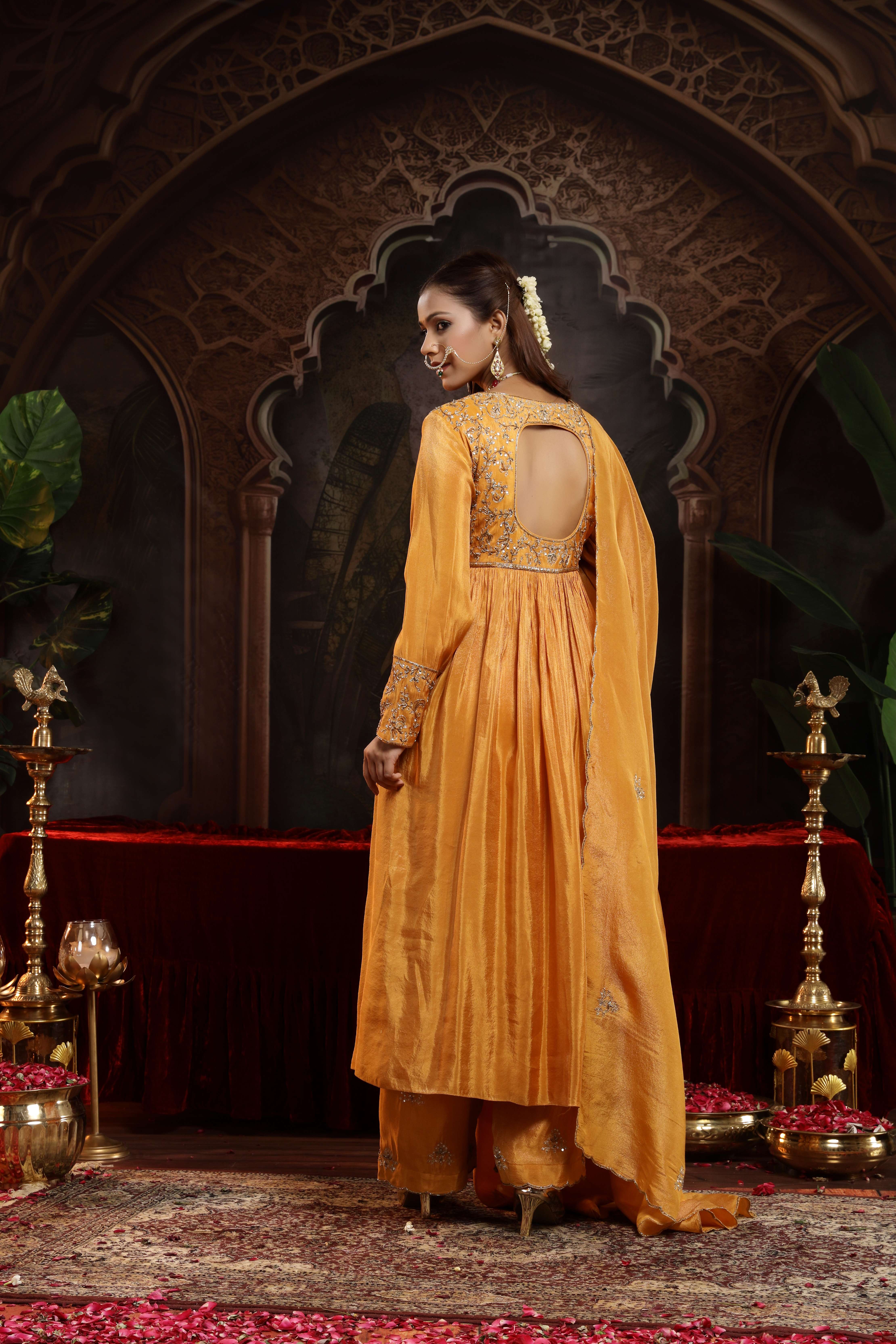 A model showcasing Aranya Mustard Anarkali Set by Miku Kumar from Miku Kumar's collection