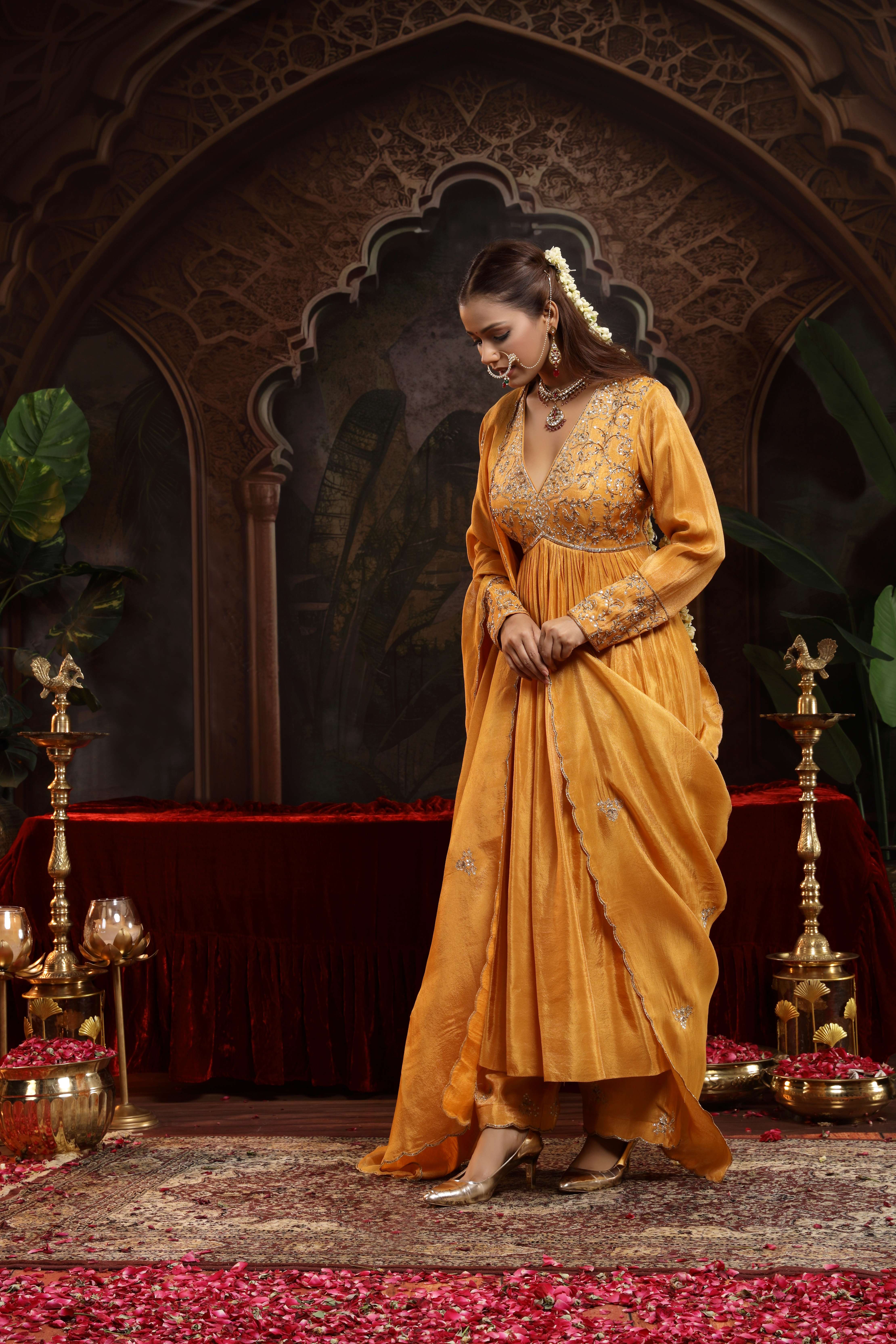 A model showcasing Aranya Mustard Anarkali Set by Miku Kumar from Miku Kumar's collection