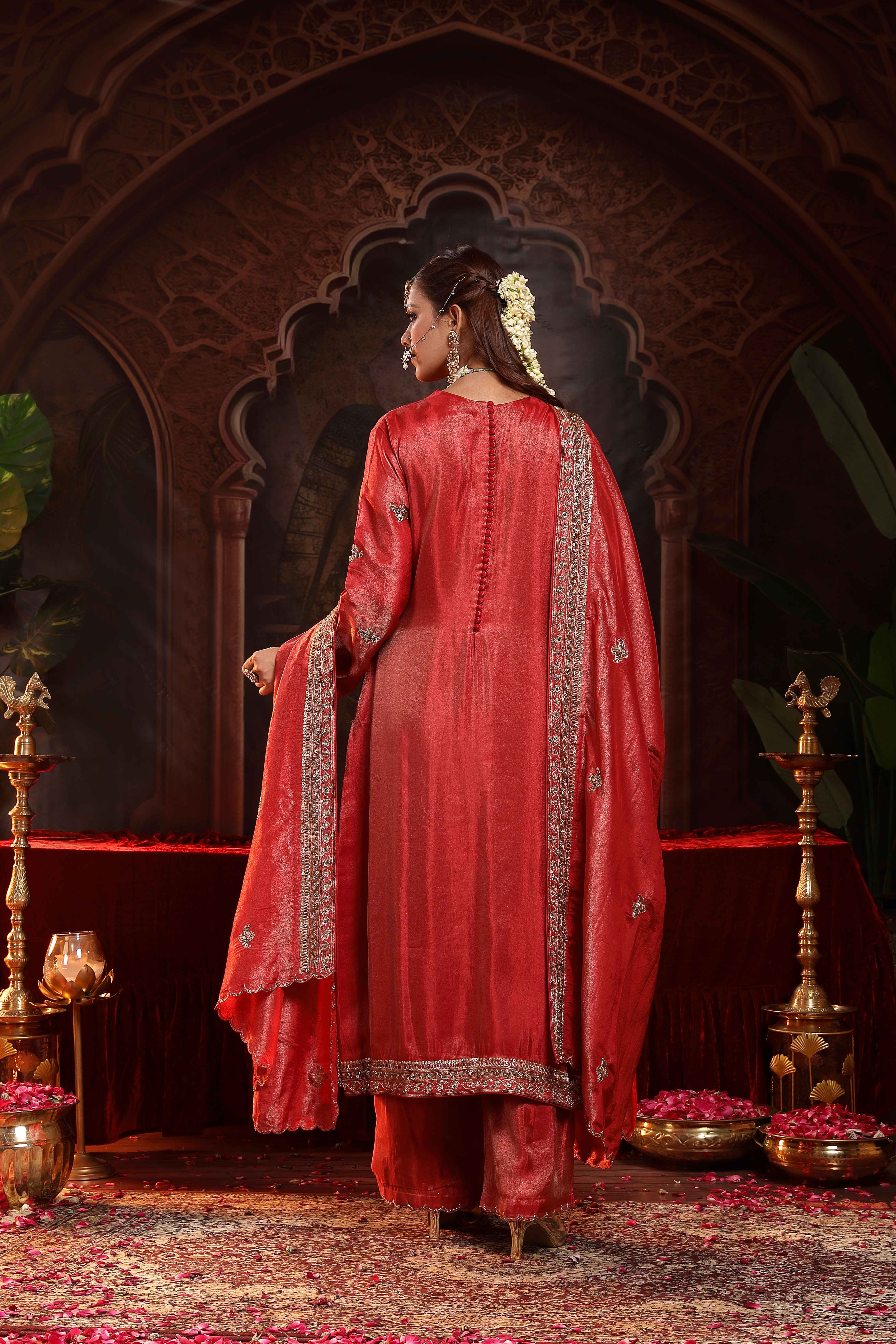 A model showcasing Prisha Red Suit Set by Miku Kumar from Miku Kumar's collection