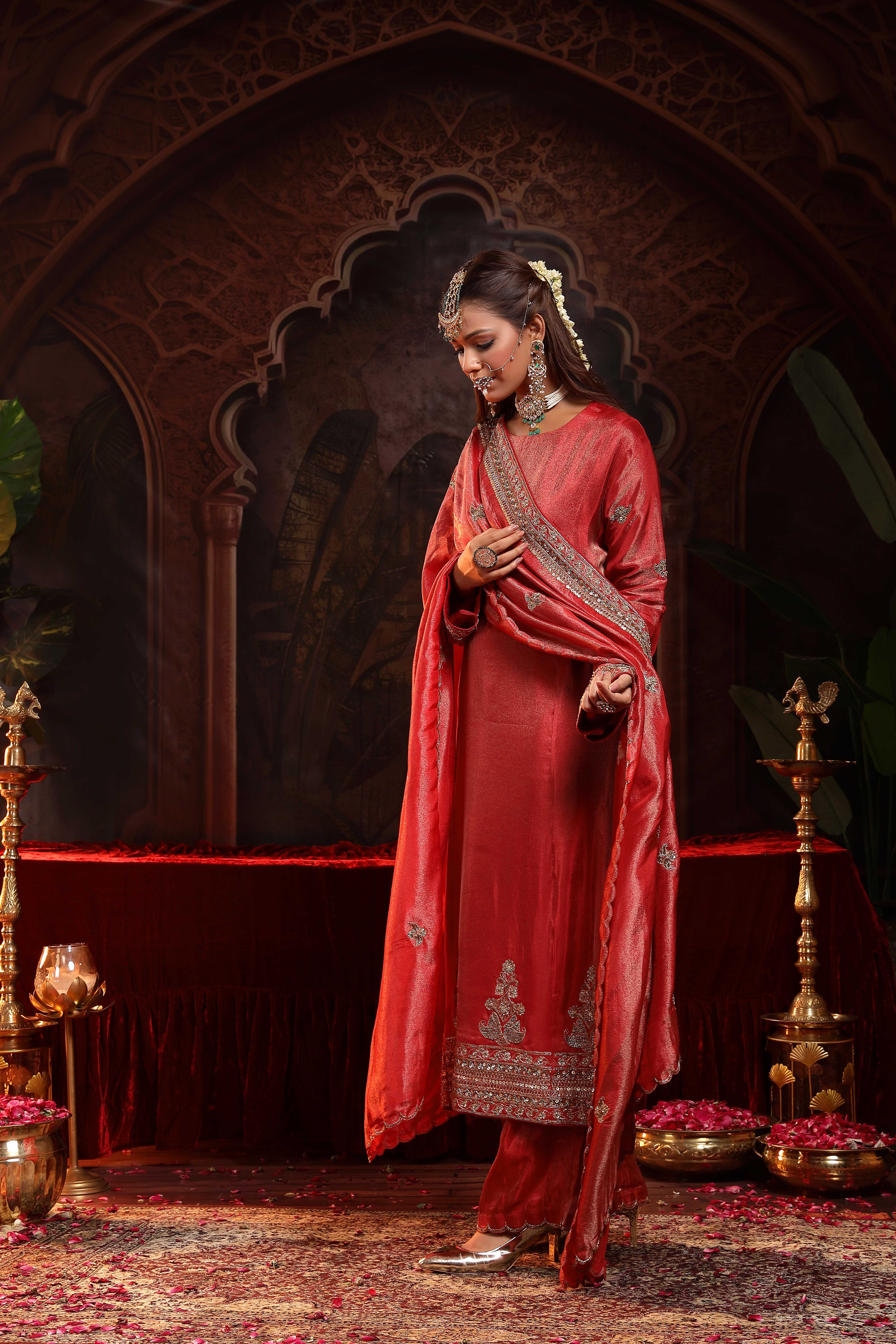 A model showcasing Prisha Red Suit Set by Miku Kumar from Miku Kumar's collection
