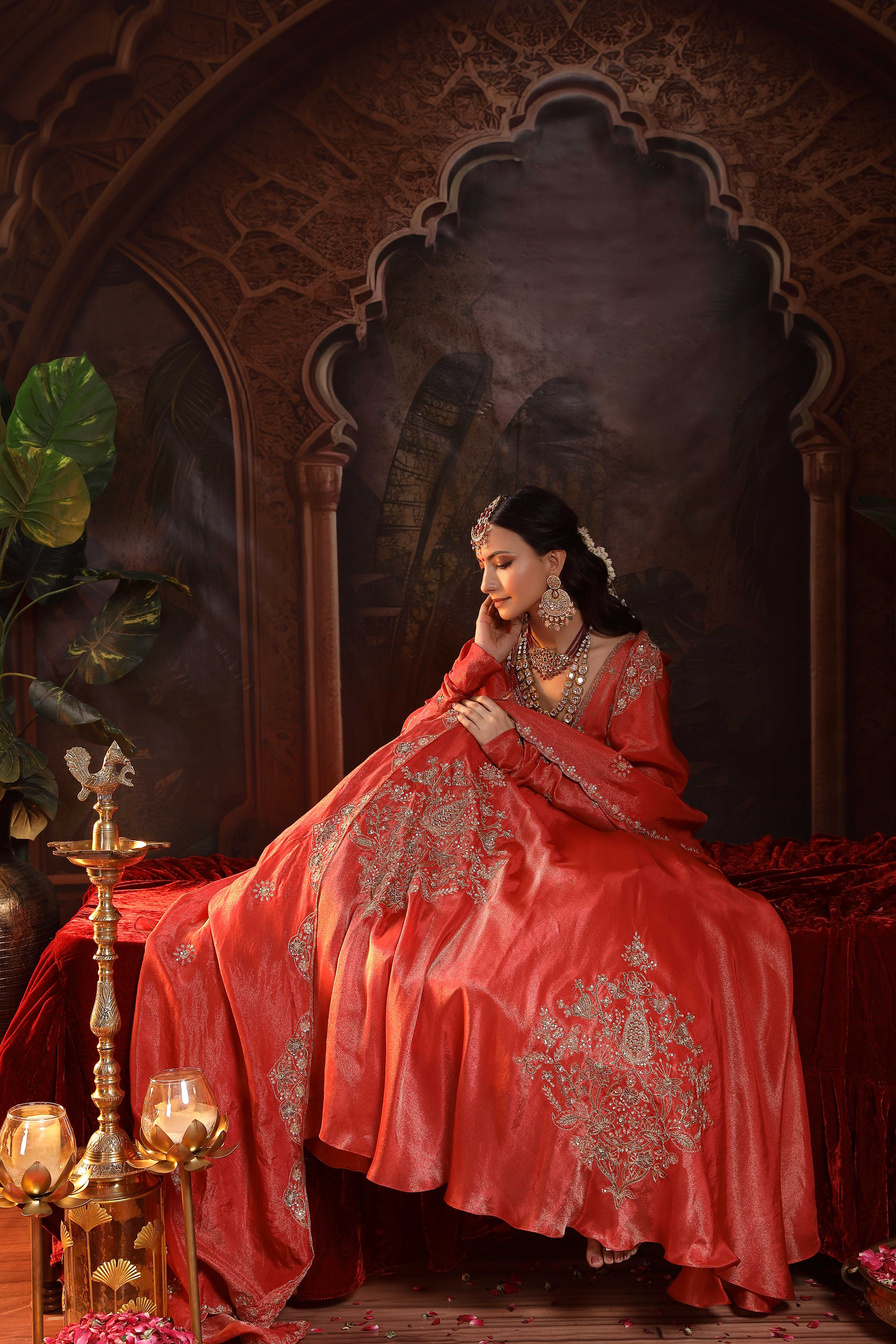 A model showcasing Shanaya Red Anarkali Set by Miku Kumar from Miku Kumar's collection