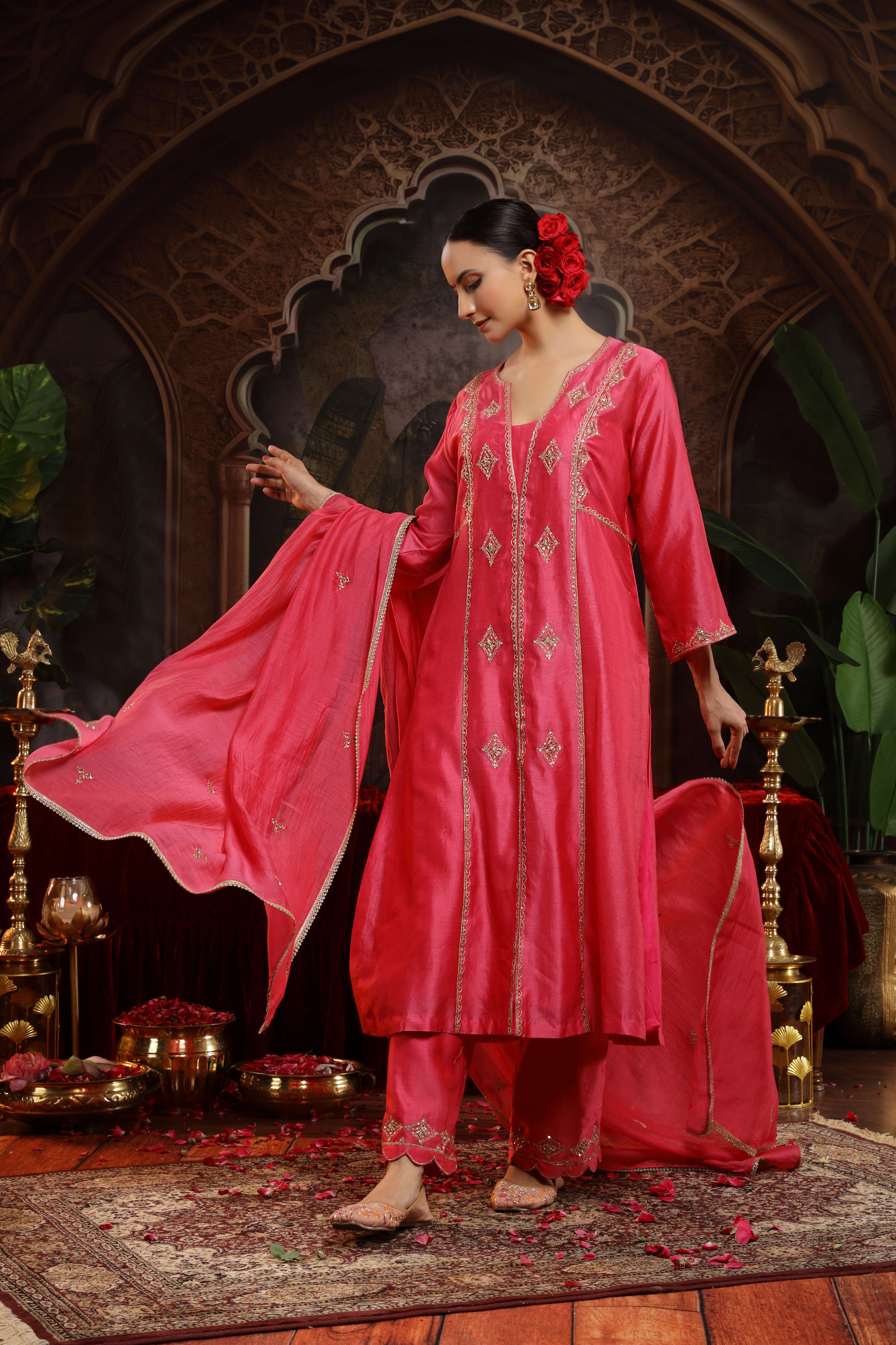 A model showcasing Suhina Hot Pink Suit by Miku Kumar from Miku Kumar's collection