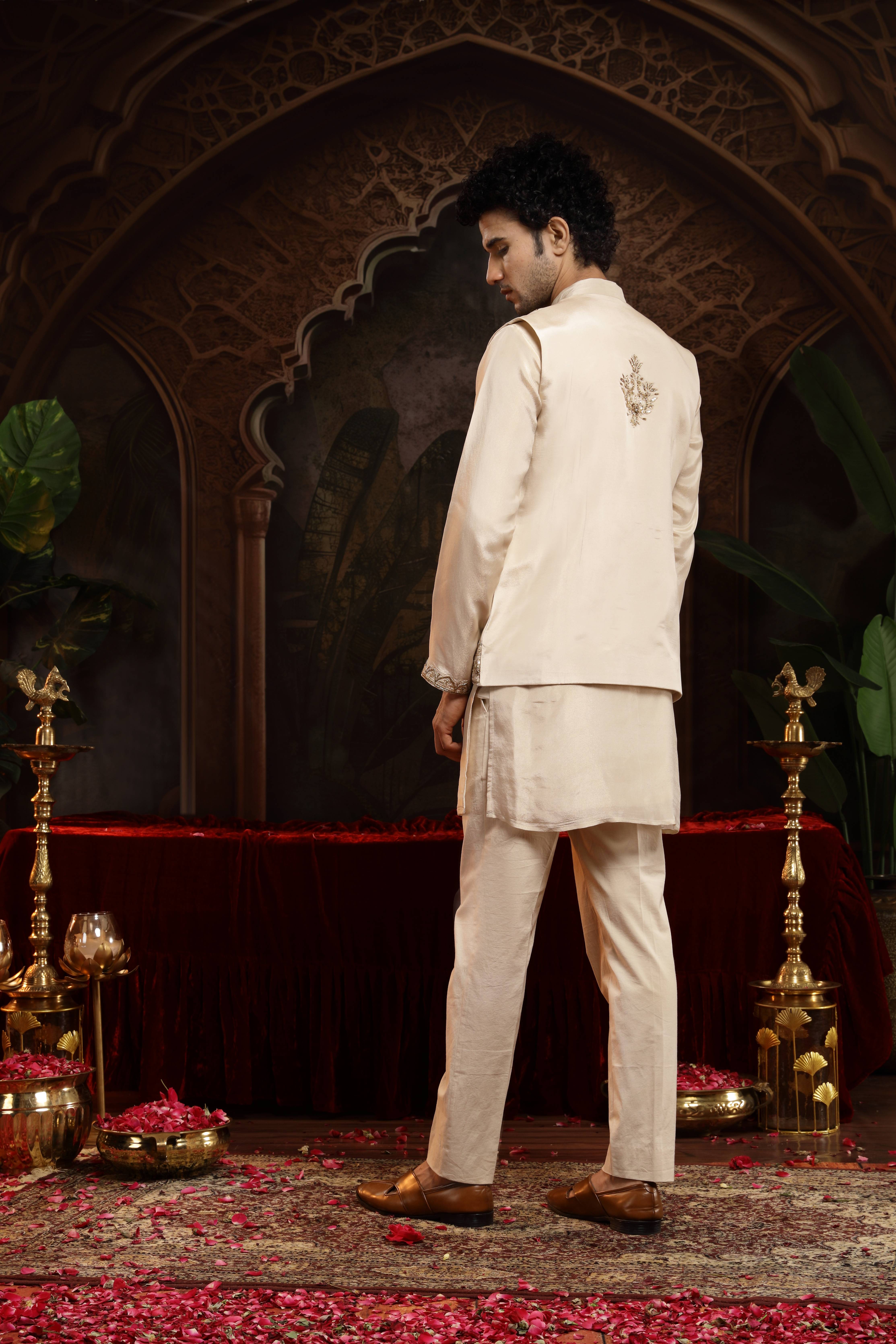 A model showcasing Vedhya Ivory Sherwani With Jacket Set by Miku Kumar from Miku Kumar's collection