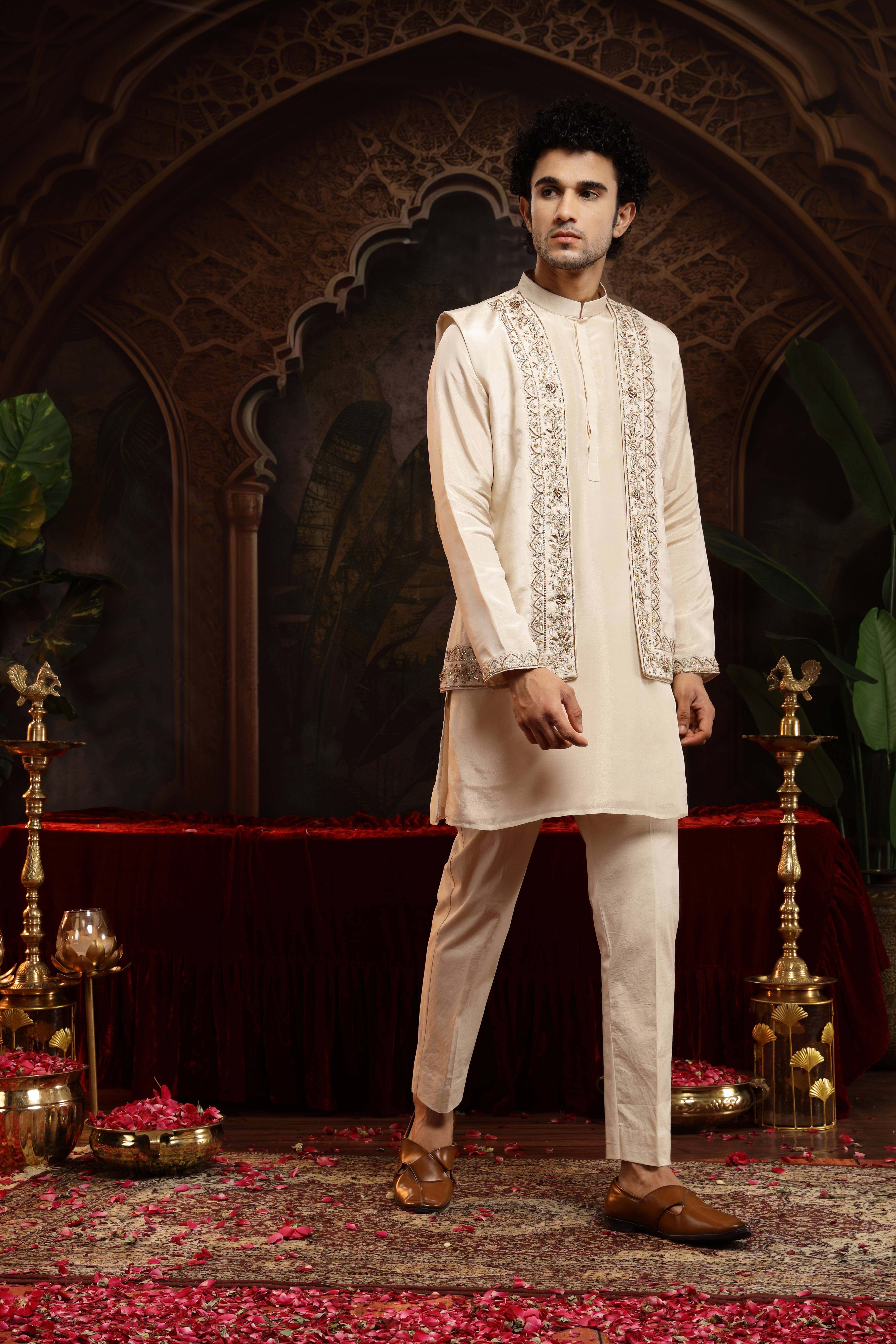 A model showcasing Vedhya Ivory Sherwani With Jacket Set by Miku Kumar from Miku Kumar's collection
