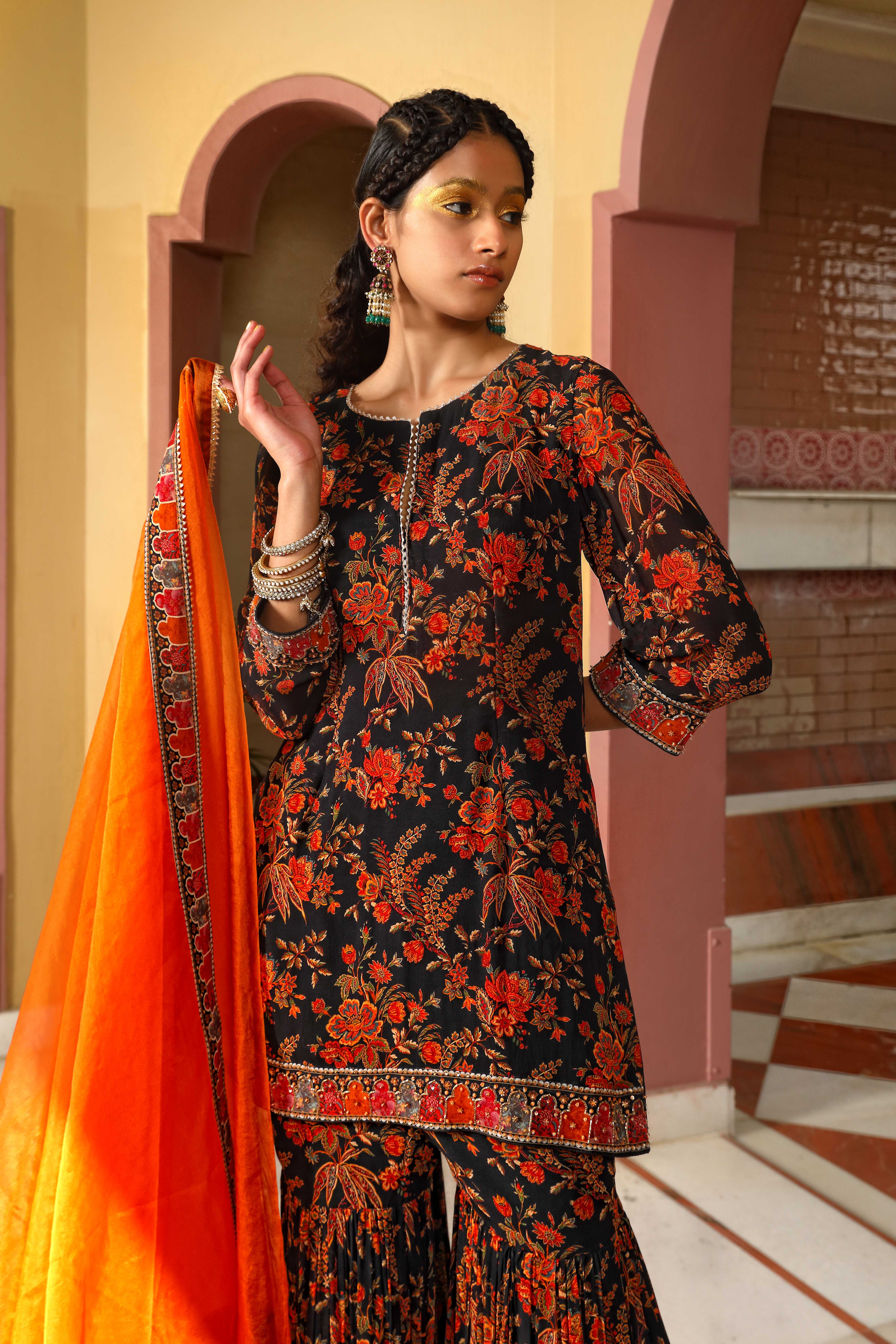 A model showcasing Printed Black Sharara Set by Mavish from Mavish's collection