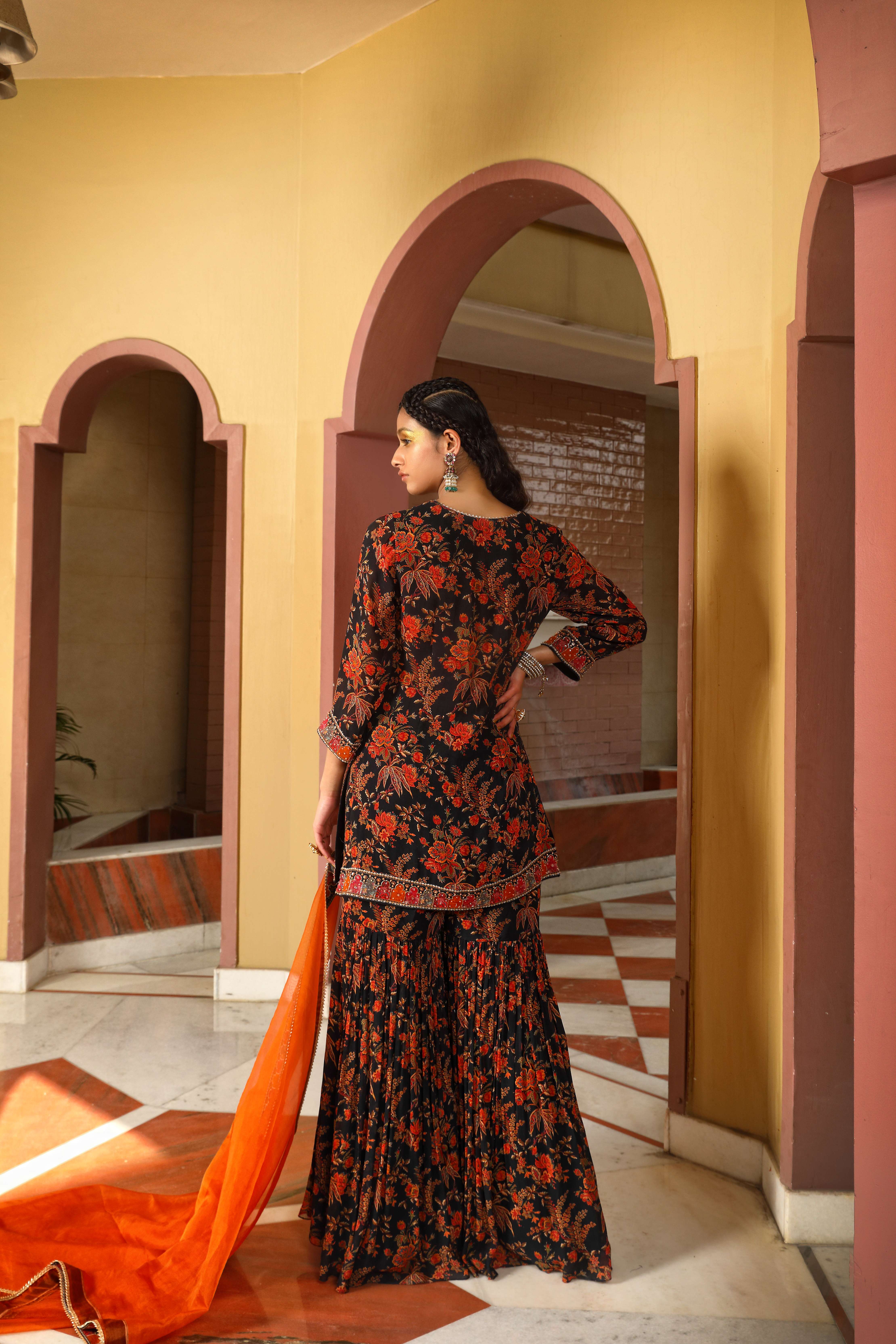 A model showcasing Printed Black Sharara Set by Mavish from Mavish's collection