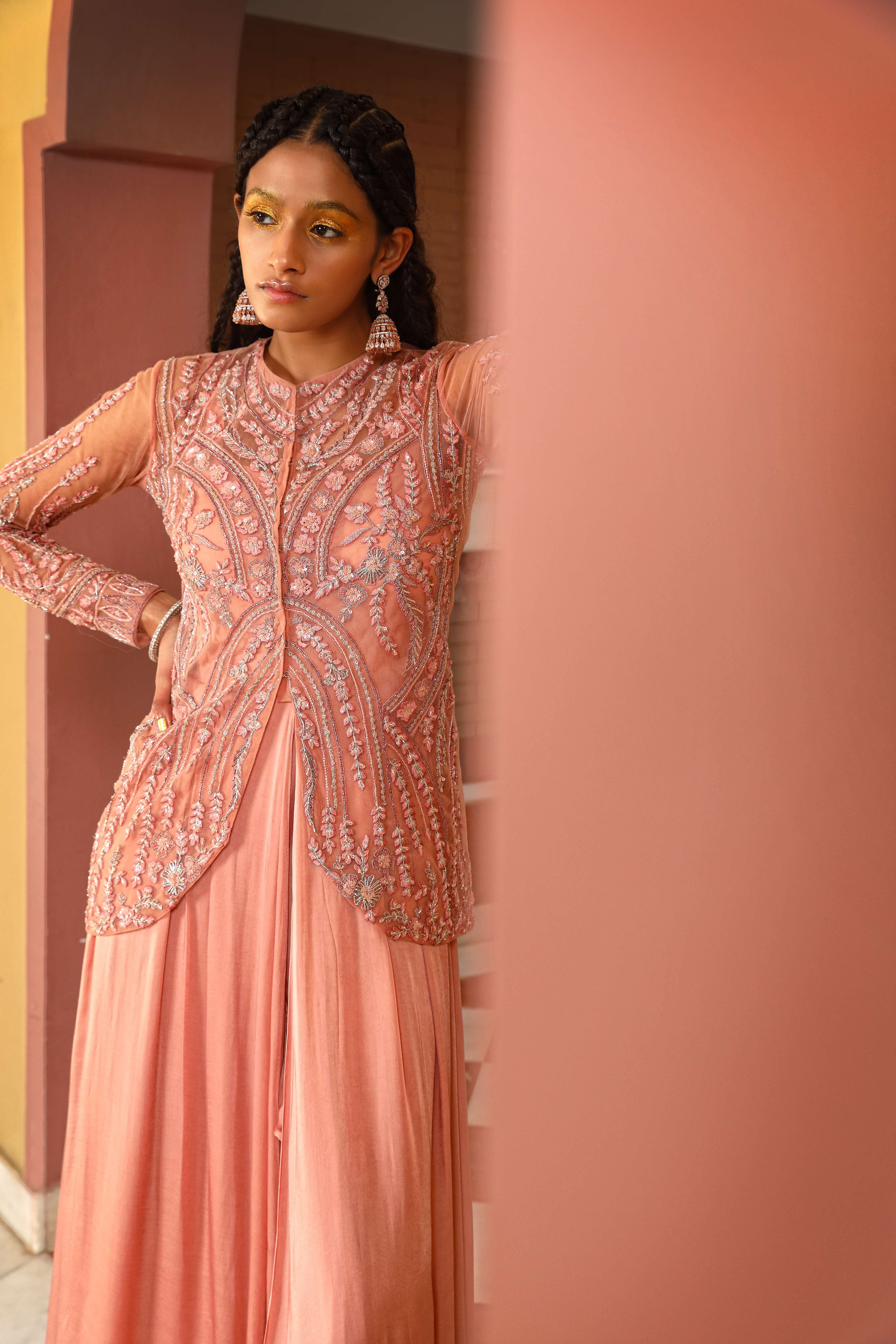 A model showcasing Layered Gown Sharara Jacket Set by Mavish from Mavish's collection