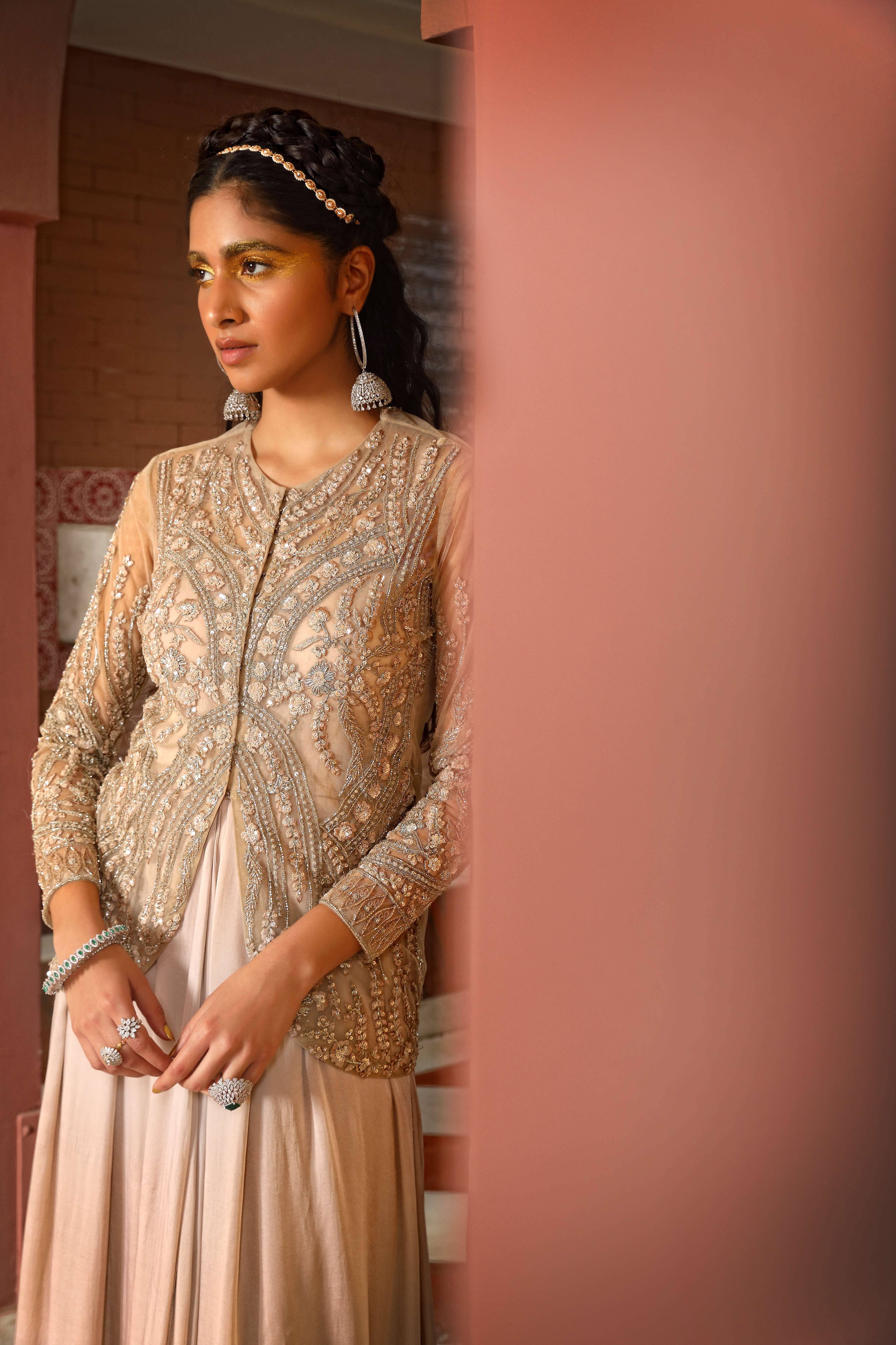 A model showcasing Champagne Layered Gown Sharara Jacket Set by Mavish from Mavish's collection