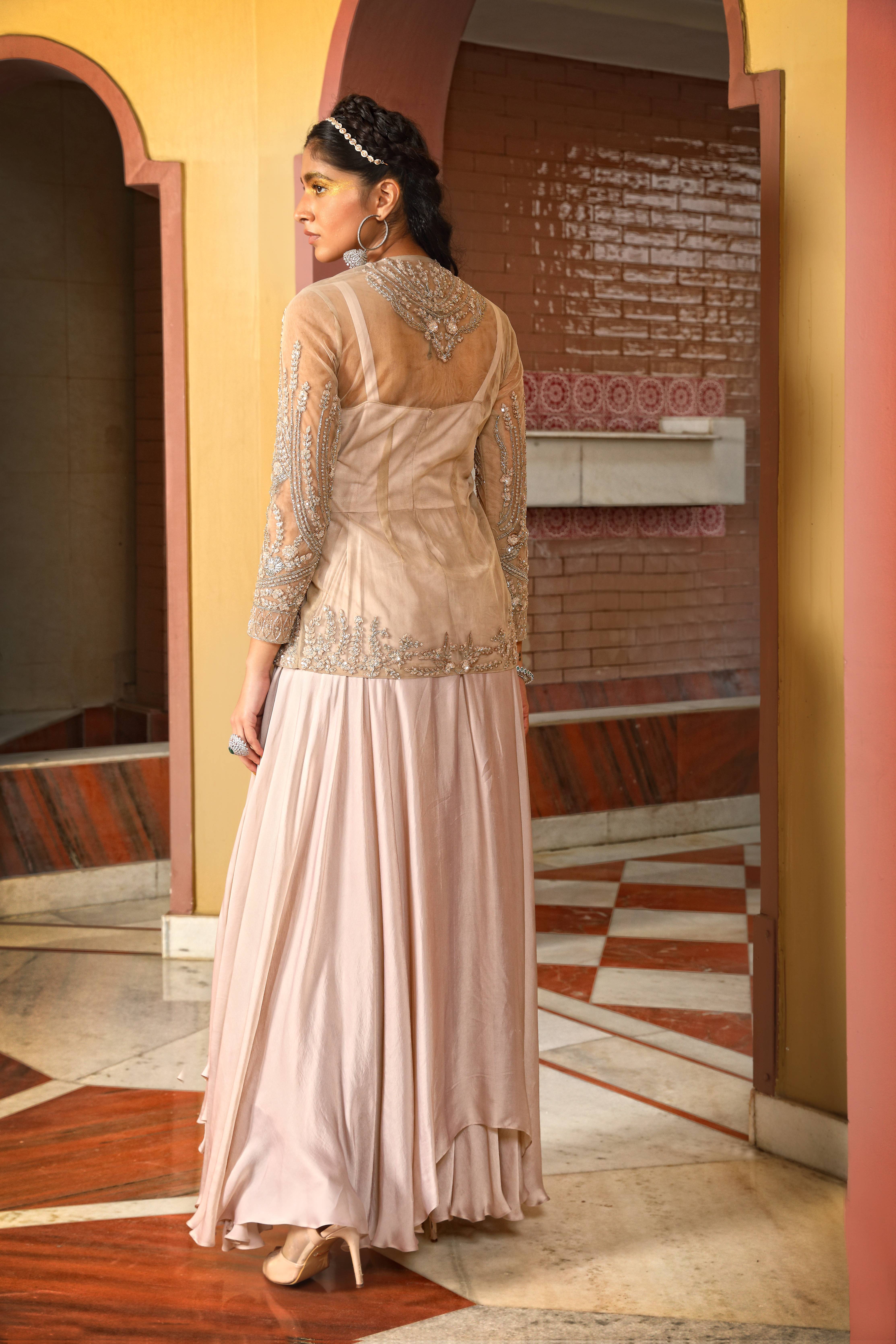 A model showcasing Champagne Layered Gown Sharara Jacket Set by Mavish from Mavish's collection