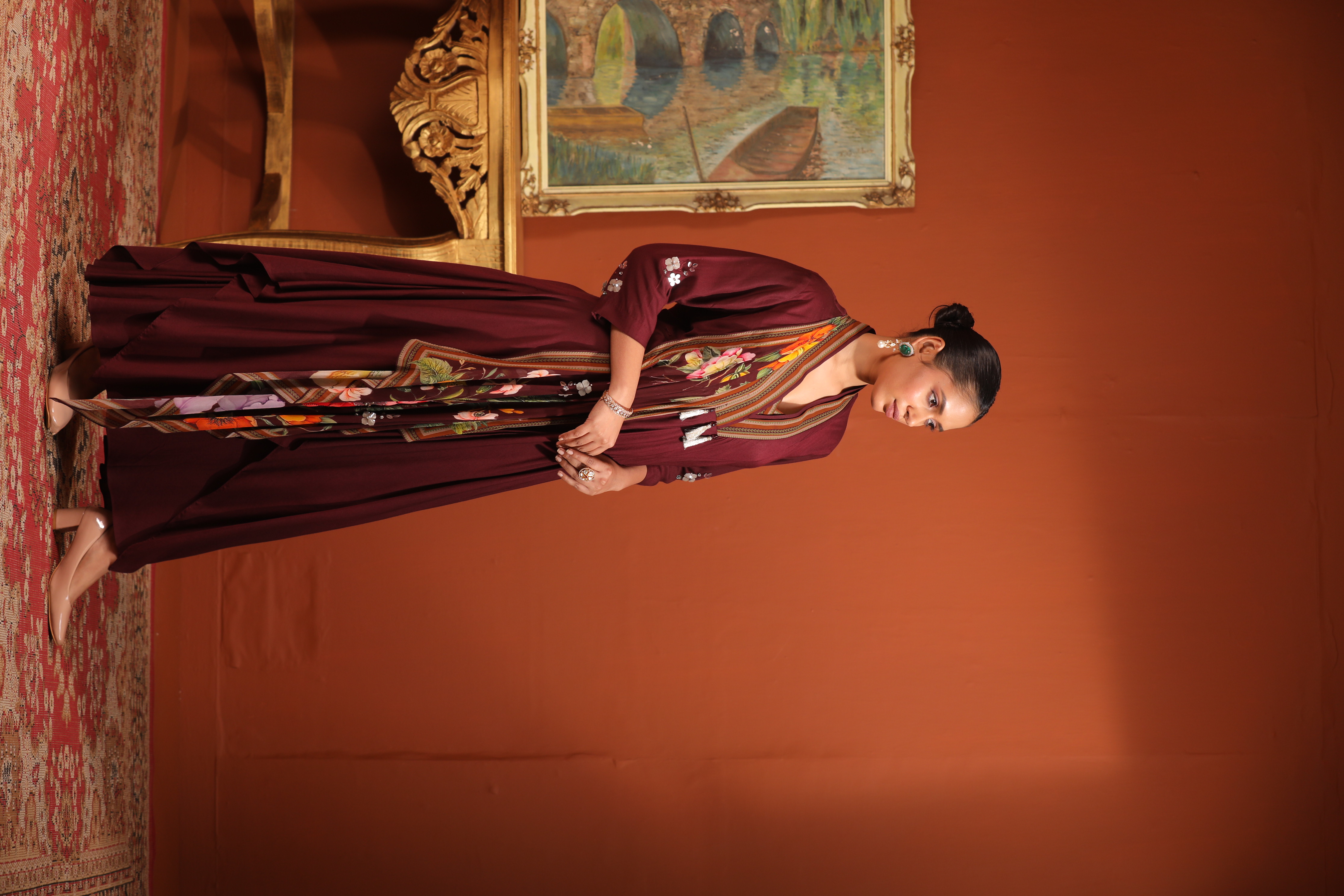 A model showcasing Maroon Layered Drape Anarkali by Mavish from Mavish's collection