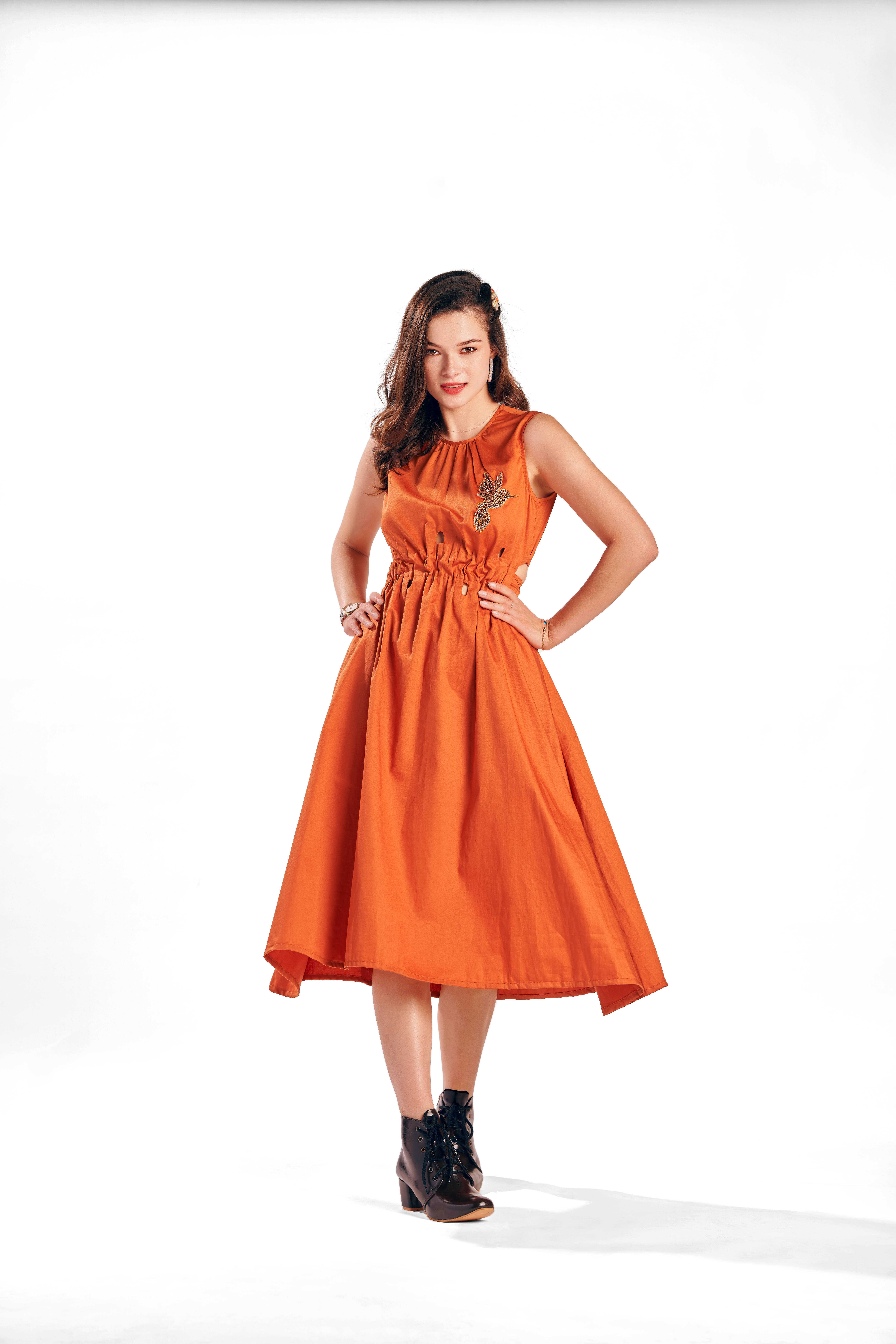 A model showcasing Aspen Rust Fit Dress by Zilaire from Zilaire's collection