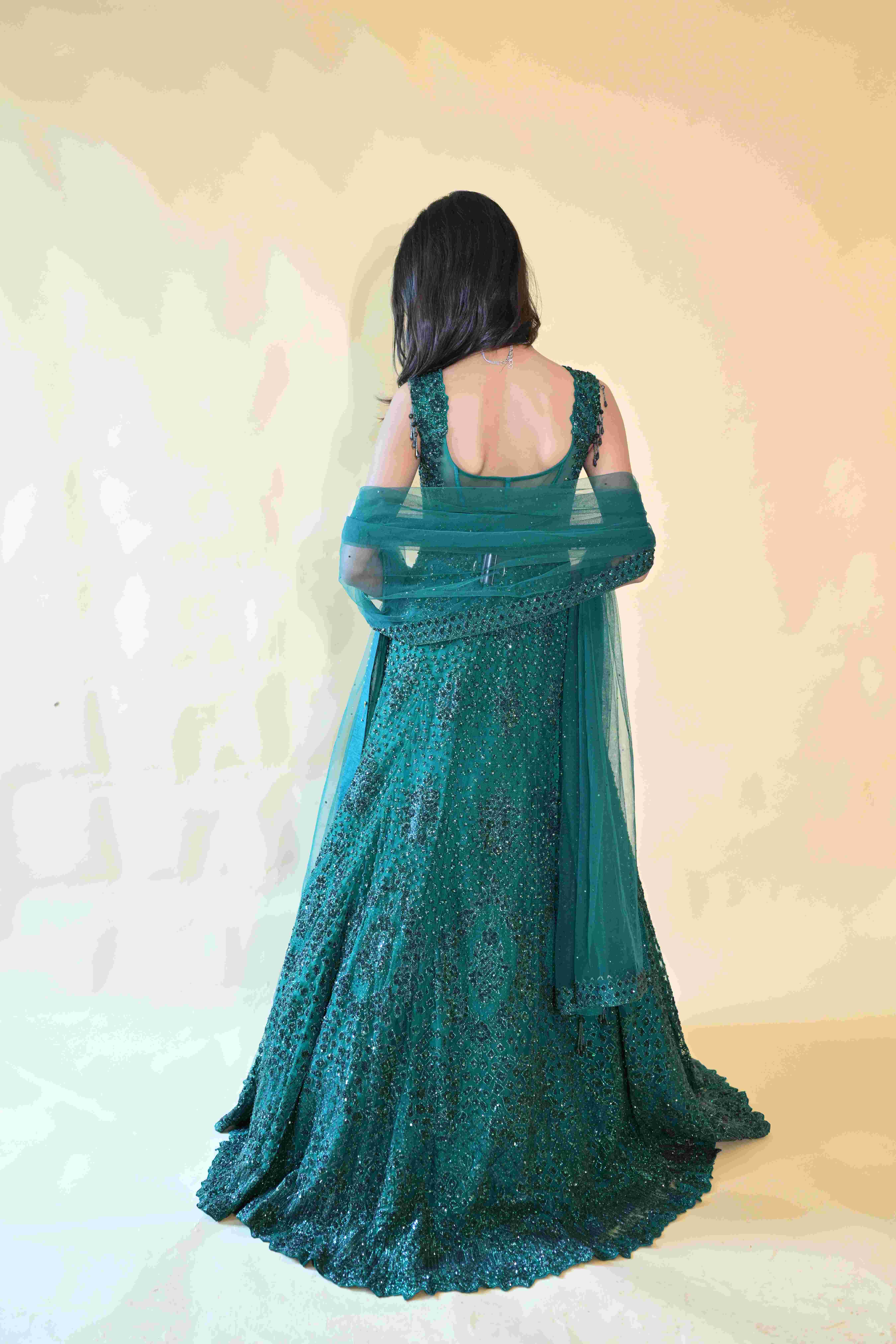 A model showcasing Emerald Gown With Dupatta by Manvi And Manik from Manvi And Manik's collection A model showcasing Emerald Gown With Dupatta by Manvi And Manik from Manvi And Manik's collection