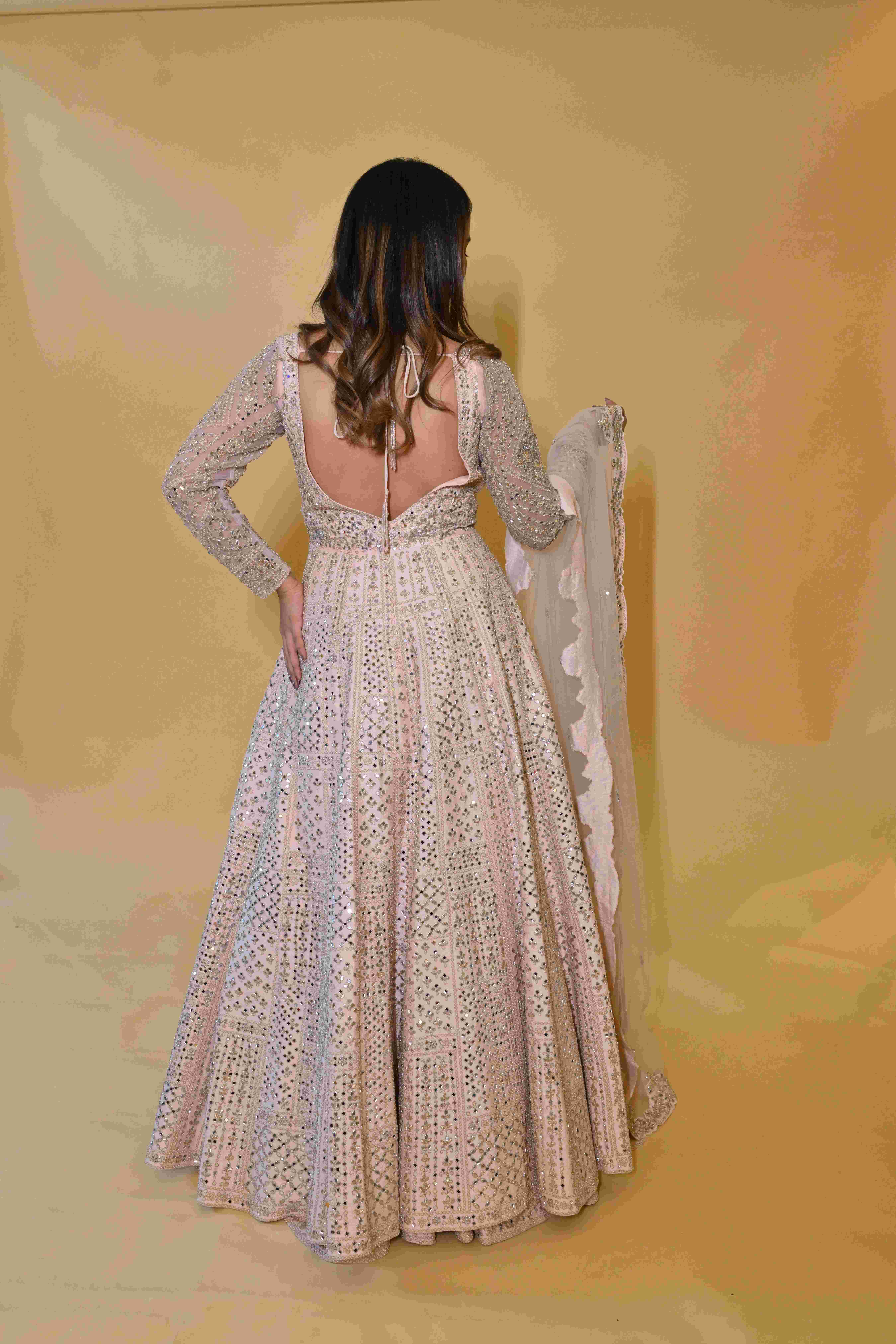 A model showcasing Light Pink Anarkali Suit by Manvi And Manik from Manvi And Manik's collection A model showcasing Light Pink Anarkali Suit by Manvi And Manik from Manvi And Manik's collection