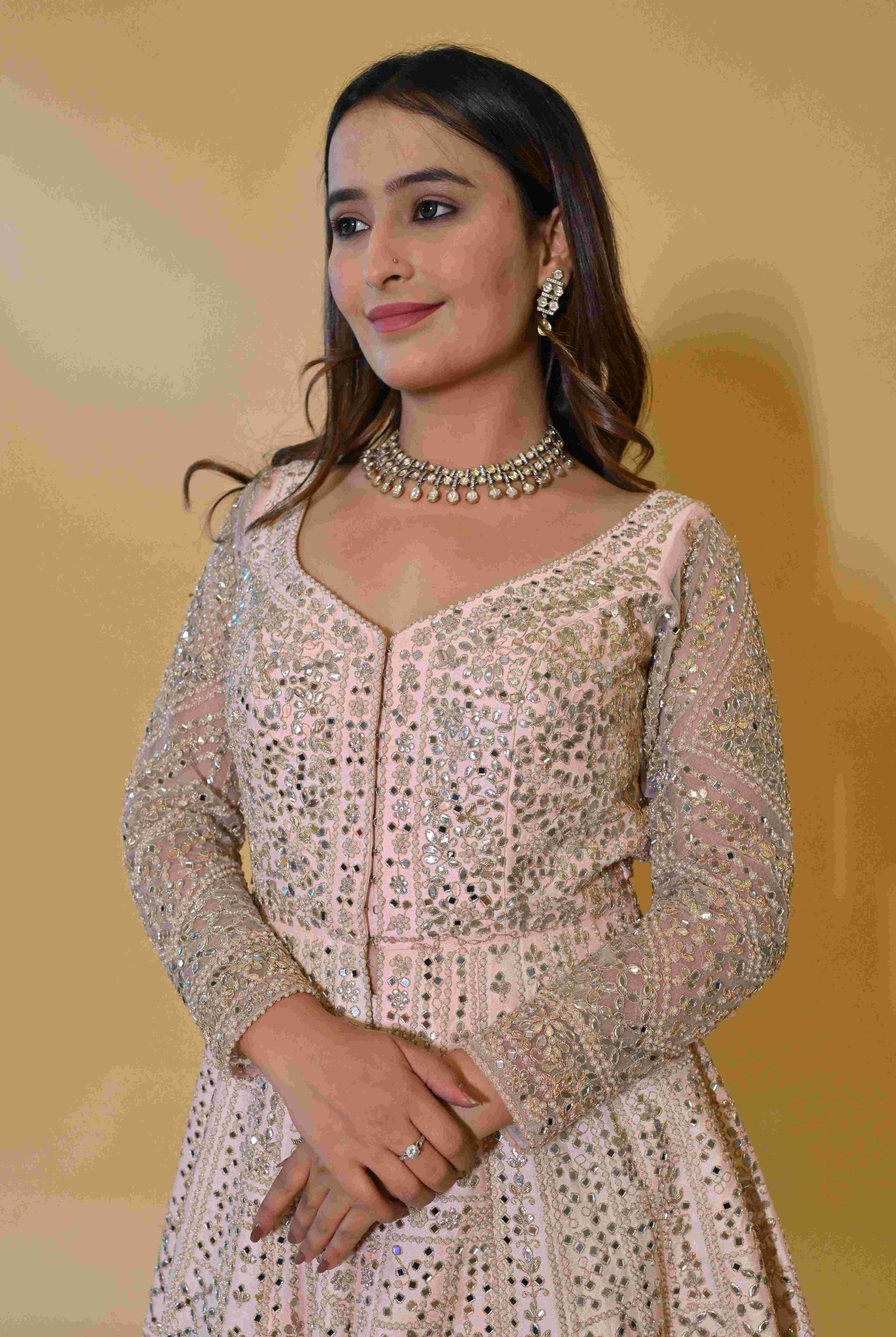 A model showcasing Light Pink Anarkali Suit by Manvi And Manik from Manvi And Manik's collection A model showcasing Light Pink Anarkali Suit by Manvi And Manik from Manvi And Manik's collection