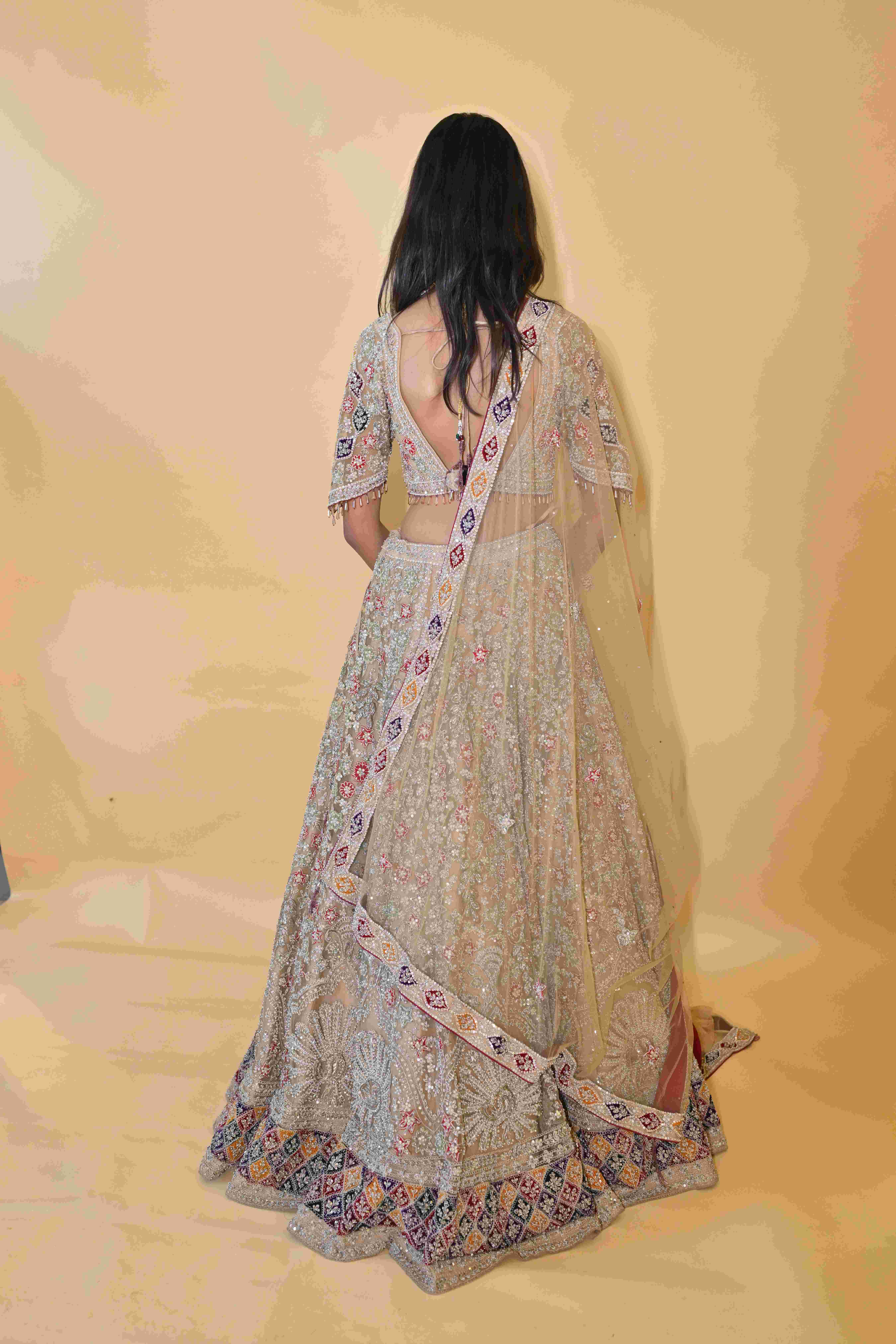 A model showcasing Golden Lehenga Choli Set by Manvi And Manik from Manvi And Manik's collection A model showcasing Golden Lehenga Choli Set by Manvi And Manik from Manvi And Manik's collection