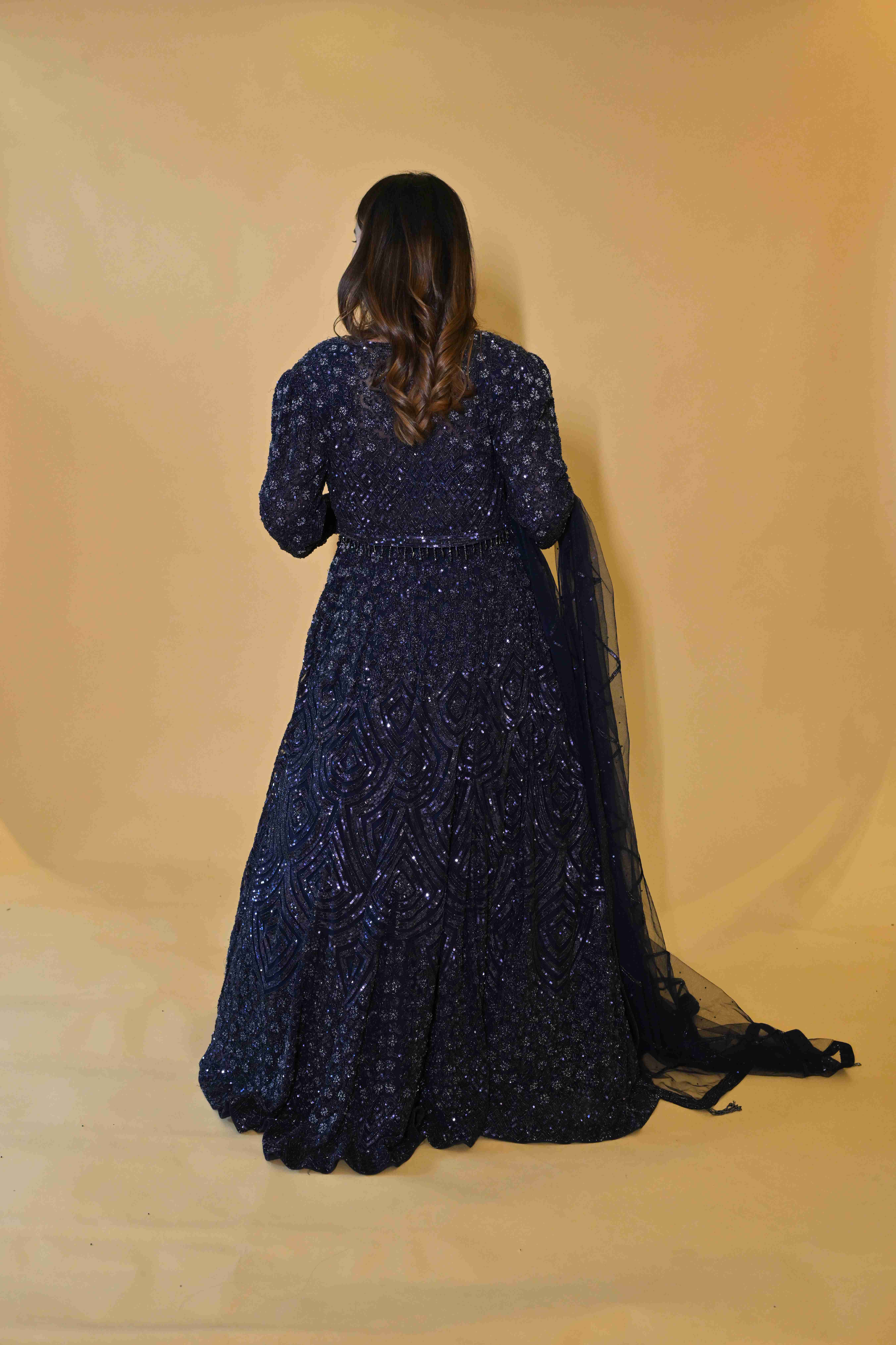 A model showcasing Navy Blue Jacket Lehenga Set by Manvi And Manik from Manvi And Manik's collection