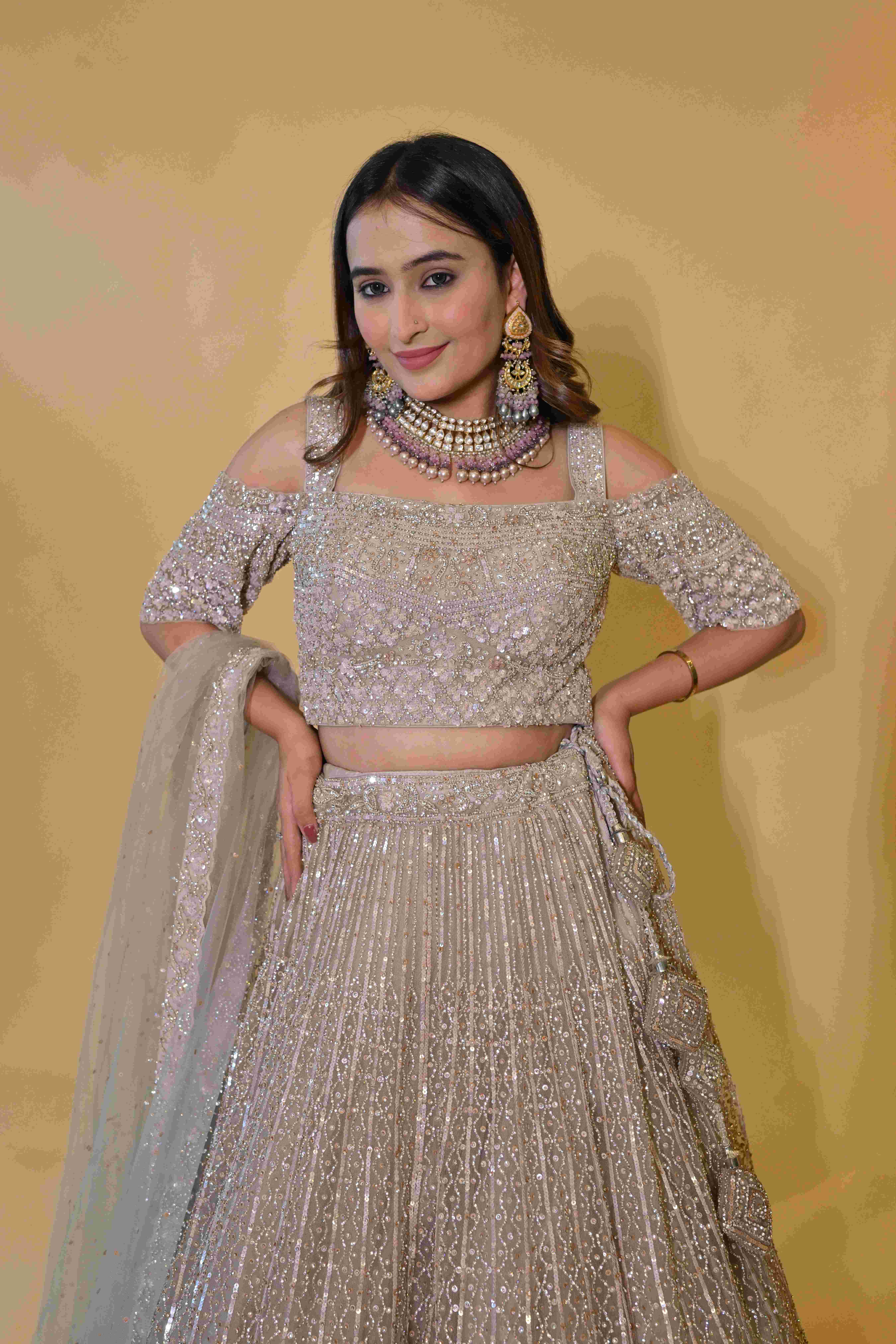 A model showcasing Beige Lehenga Choli Set by Labell Patchouli from Labell Patchouli's collection A model showcasing Beige Lehenga Choli Set by Labell Patchouli from Labell Patchouli's collection