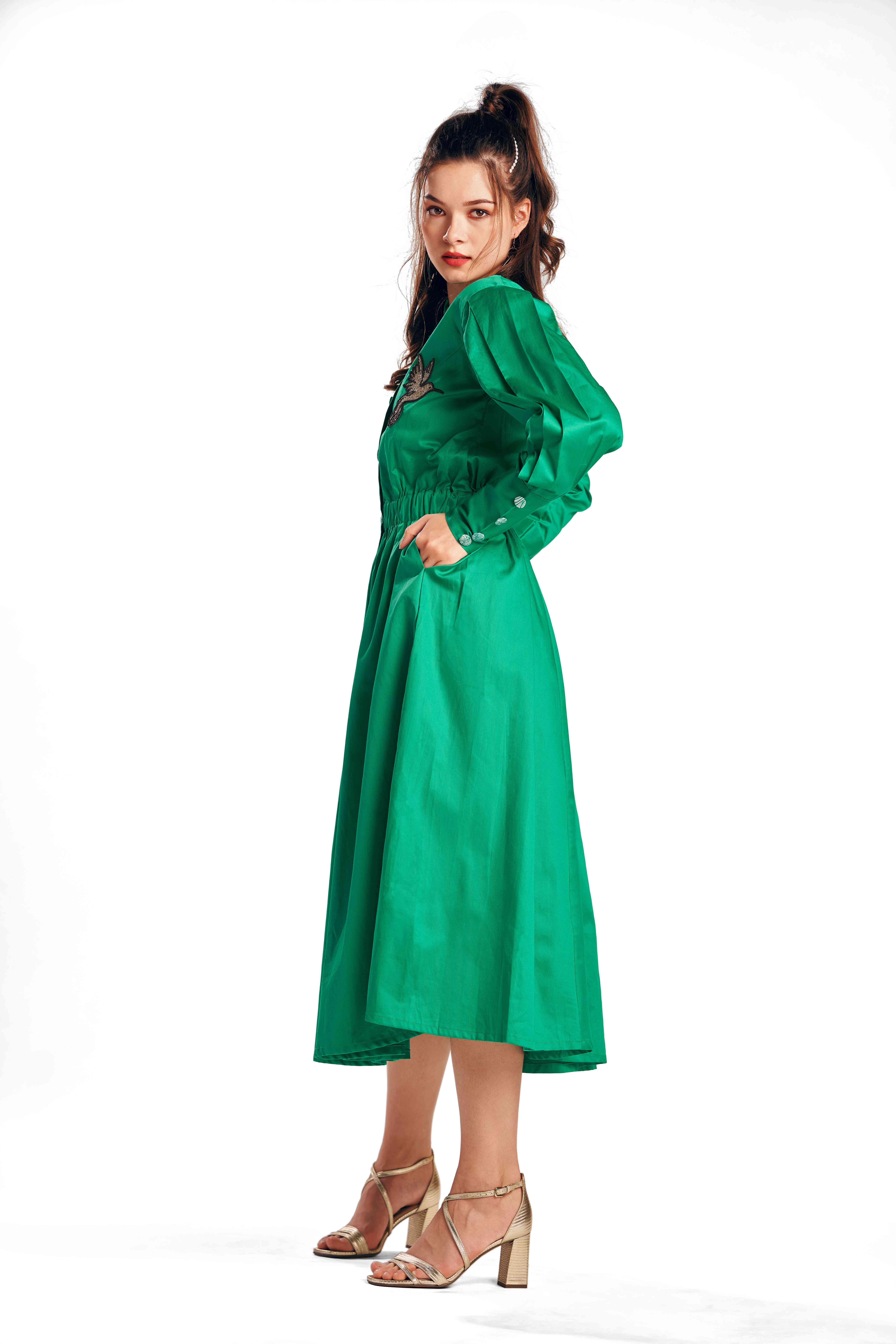 A model showcasing Alcedo Bird Green Dress by Zilaire from Zilaire's collection