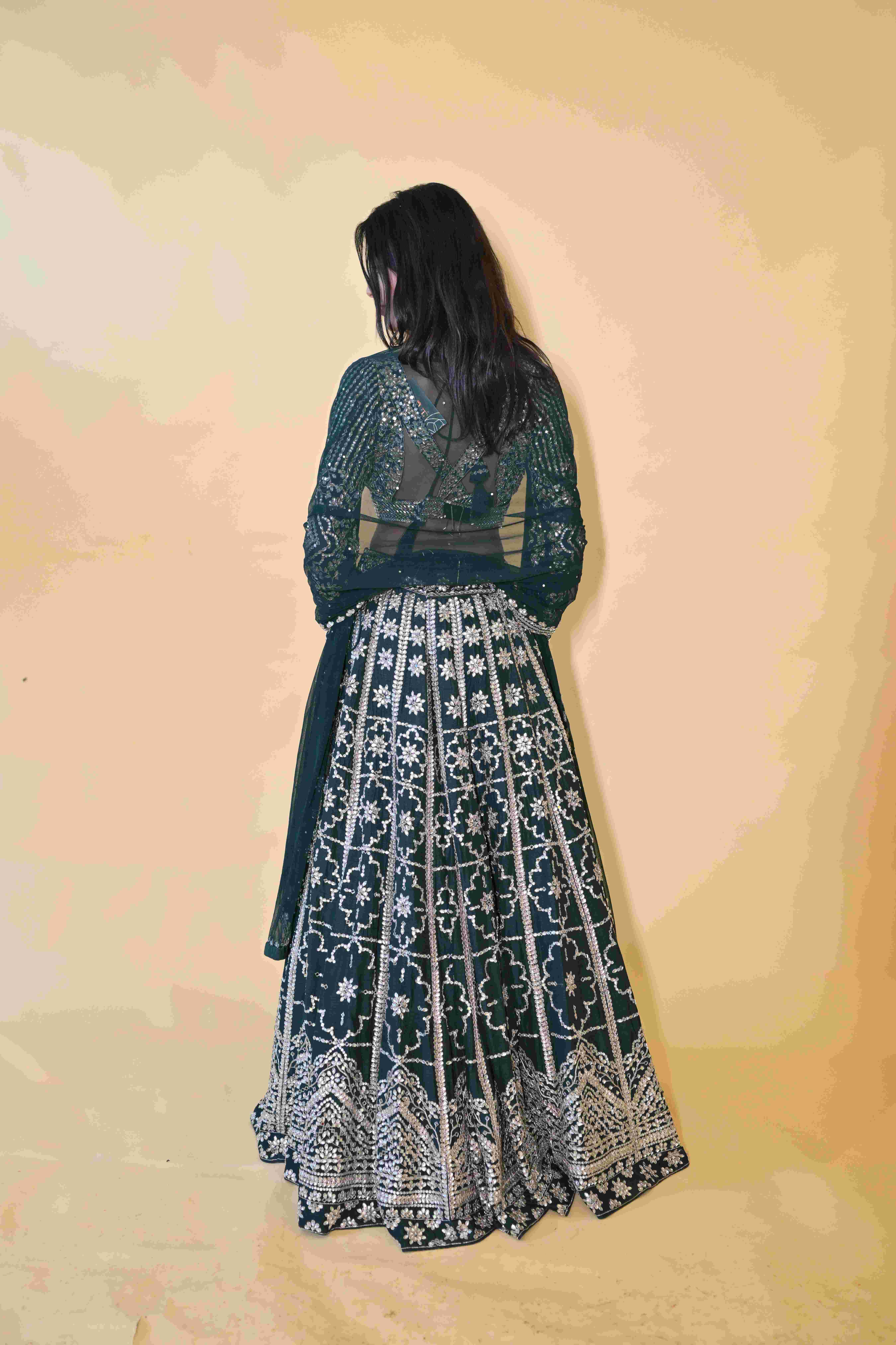 A model showcasing Green Lehenga Choli Set by Labell Patchouli from Labell Patchouli's collection A model showcasing Green Lehenga Choli Set by Labell Patchouli from Labell Patchouli's collection