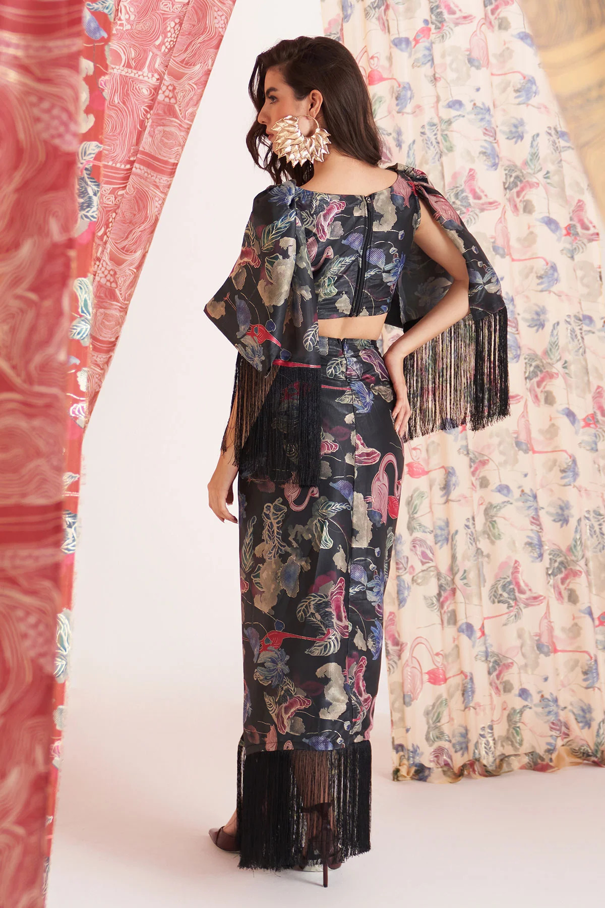 A model showcasing Duck Black Fringe Skirt Coord Set by Puneet Kapoor Label from Puneet Kapoor Label's collection A model showcasing Duck Black Fringe Skirt Coord Set by Puneet Kapoor Label from Puneet Kapoor Label's collection