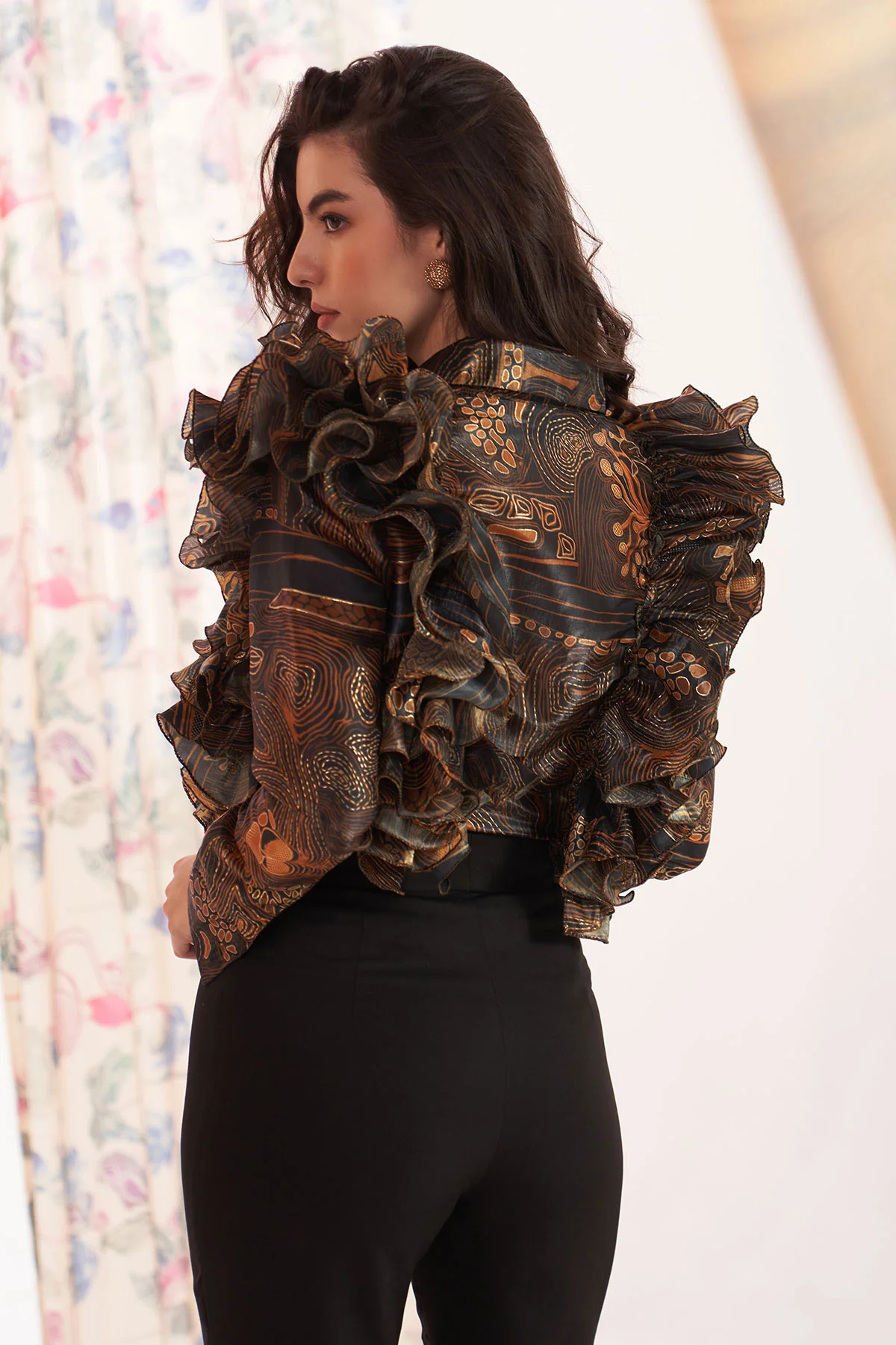 A model showcasing Zebra Brown Ruffle Shirt by Puneet Kapoor Label from Puneet Kapoor Label's collection A model showcasing Zebra Brown Ruffle Shirt by Puneet Kapoor Label from Puneet Kapoor Label's collection