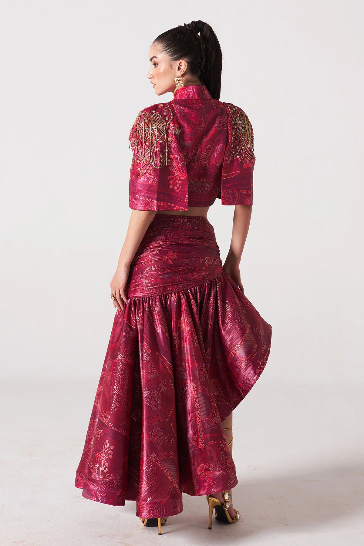 A model showcasing Fuchsia Zebra Print Slit Jacket With Ruffle Skirt by Puneet Kapoor Label from Puneet Kapoor Label's collection