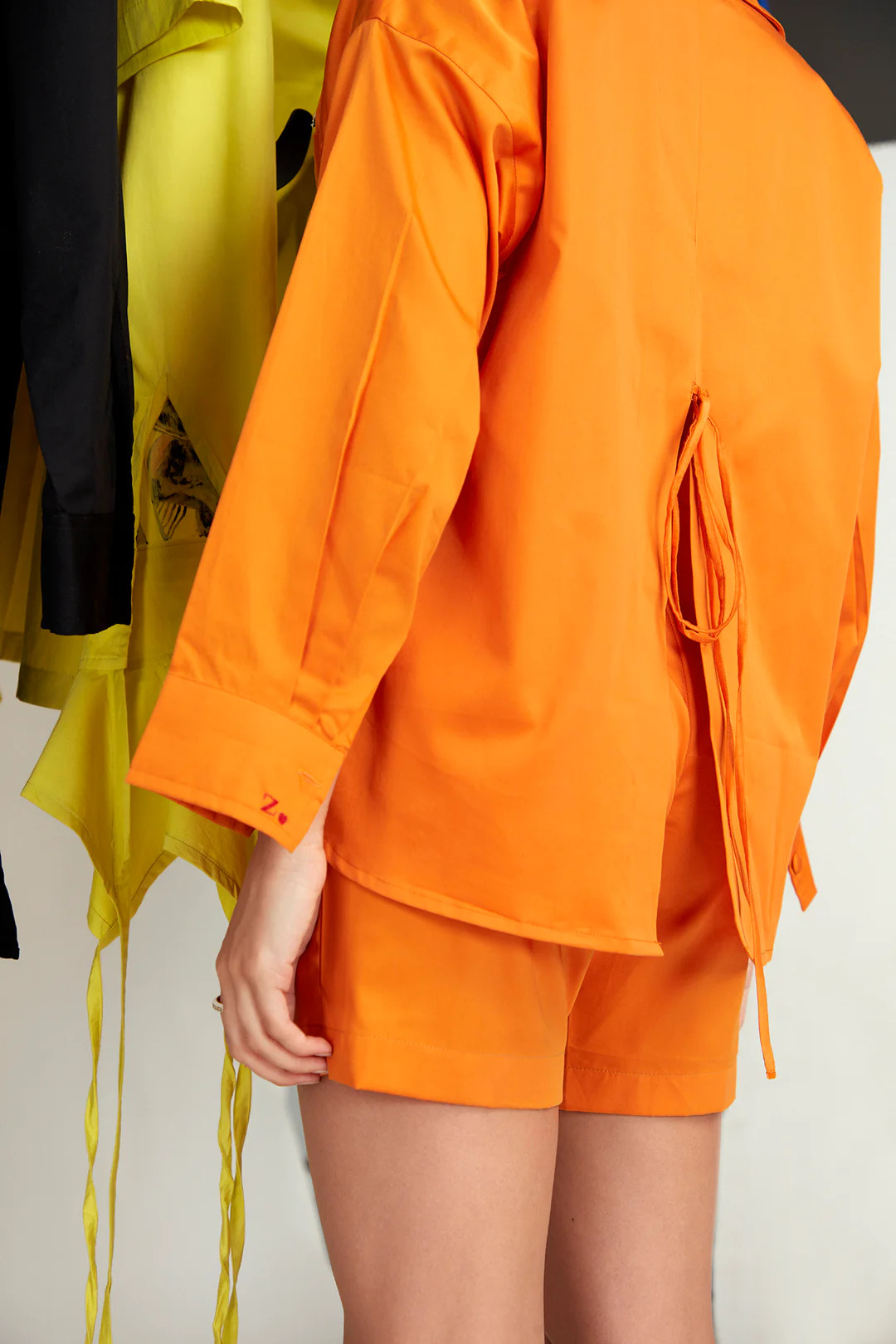 A model showcasing Blaze Orange Burst Set by Zilaire from Zilaire's collection A model showcasing Blaze Orange Burst Set by Zilaire from Zilaire's collection