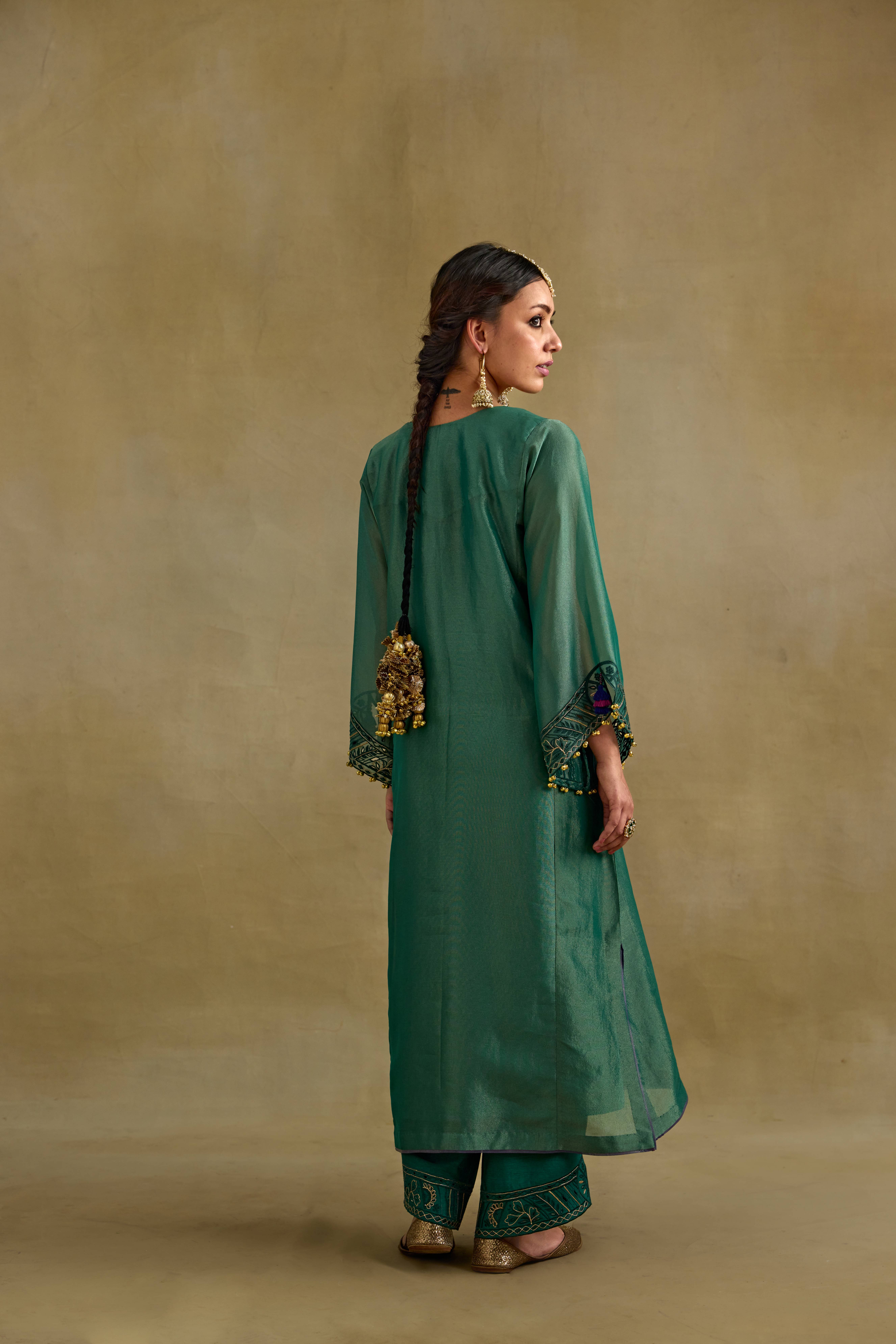 A model showcasing Amber Tissue Phiran Style Kurta Set by Nirvair from Nirvair's collection A model showcasing Amber Tissue Phiran Style Kurta Set by Nirvair from Nirvair's collection