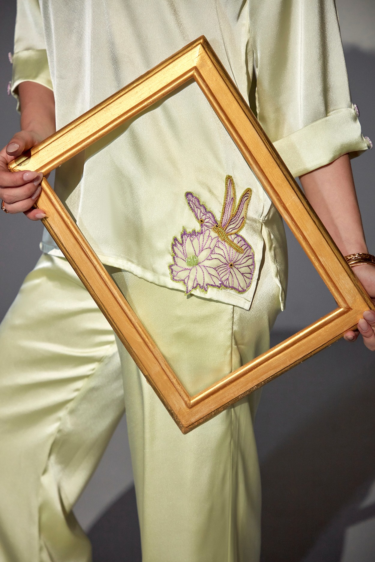 A model showcasing Mia Lime Green Swing Set by Zilaire from Zilaire's collection