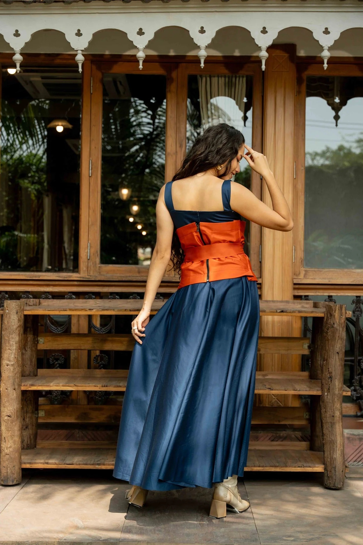 A model showcasing Miyake Midi Dress by Zilaire from Zilaire's collection