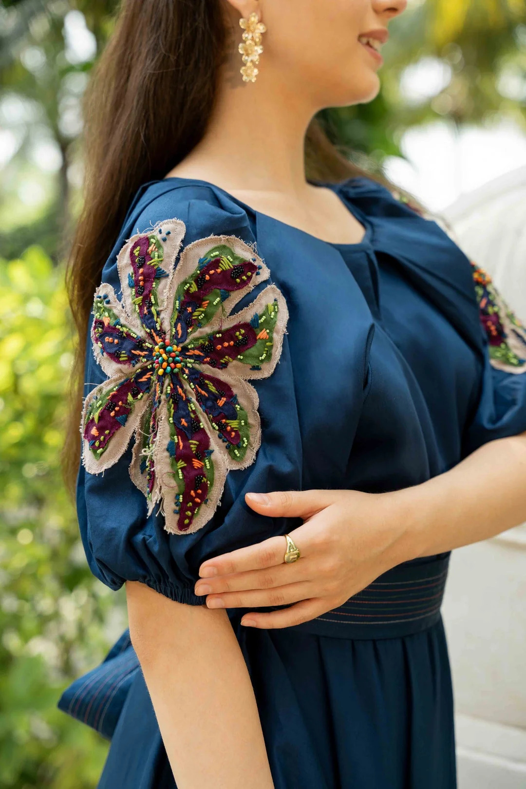 A model showcasing Miu Blue Midi Dress by Zilaire from Zilaire's collection