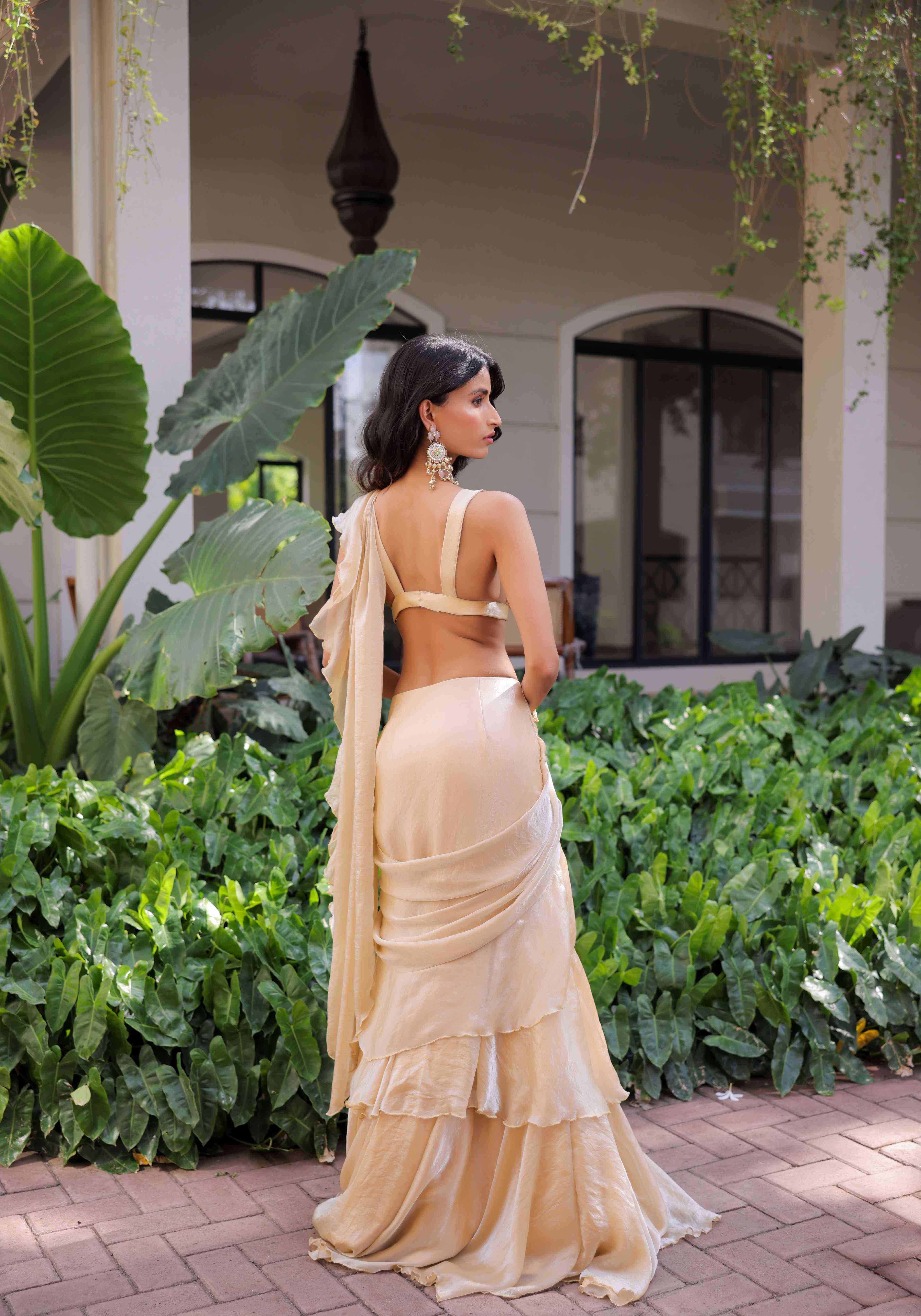 A model showcasing Cream Ruffle Draped Saree Set by Foram Patel from Foram Patel's collection