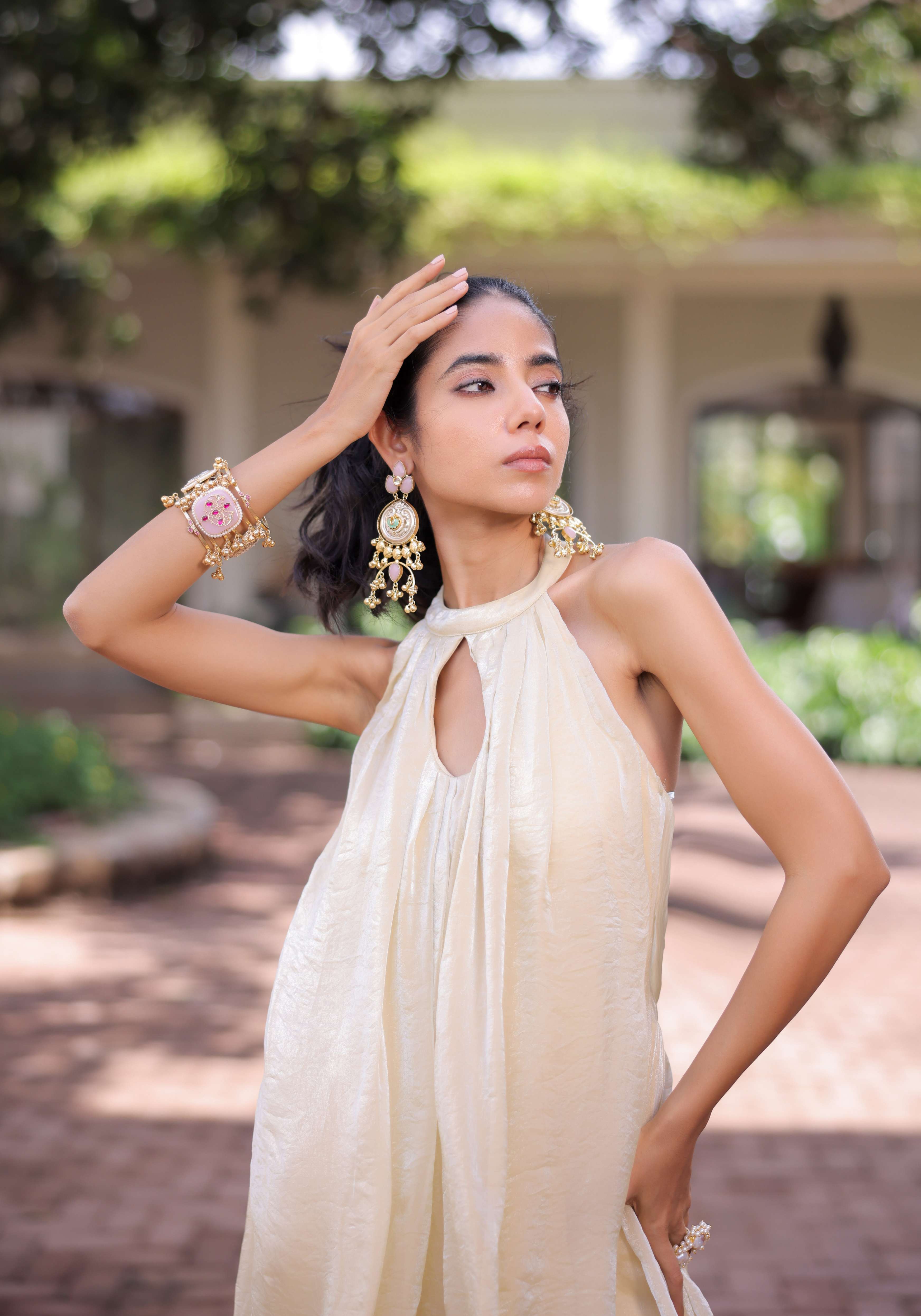 A model showcasing Cream Shimmer Pleated Jumpsuit by Foram Patel from Foram Patel's collection