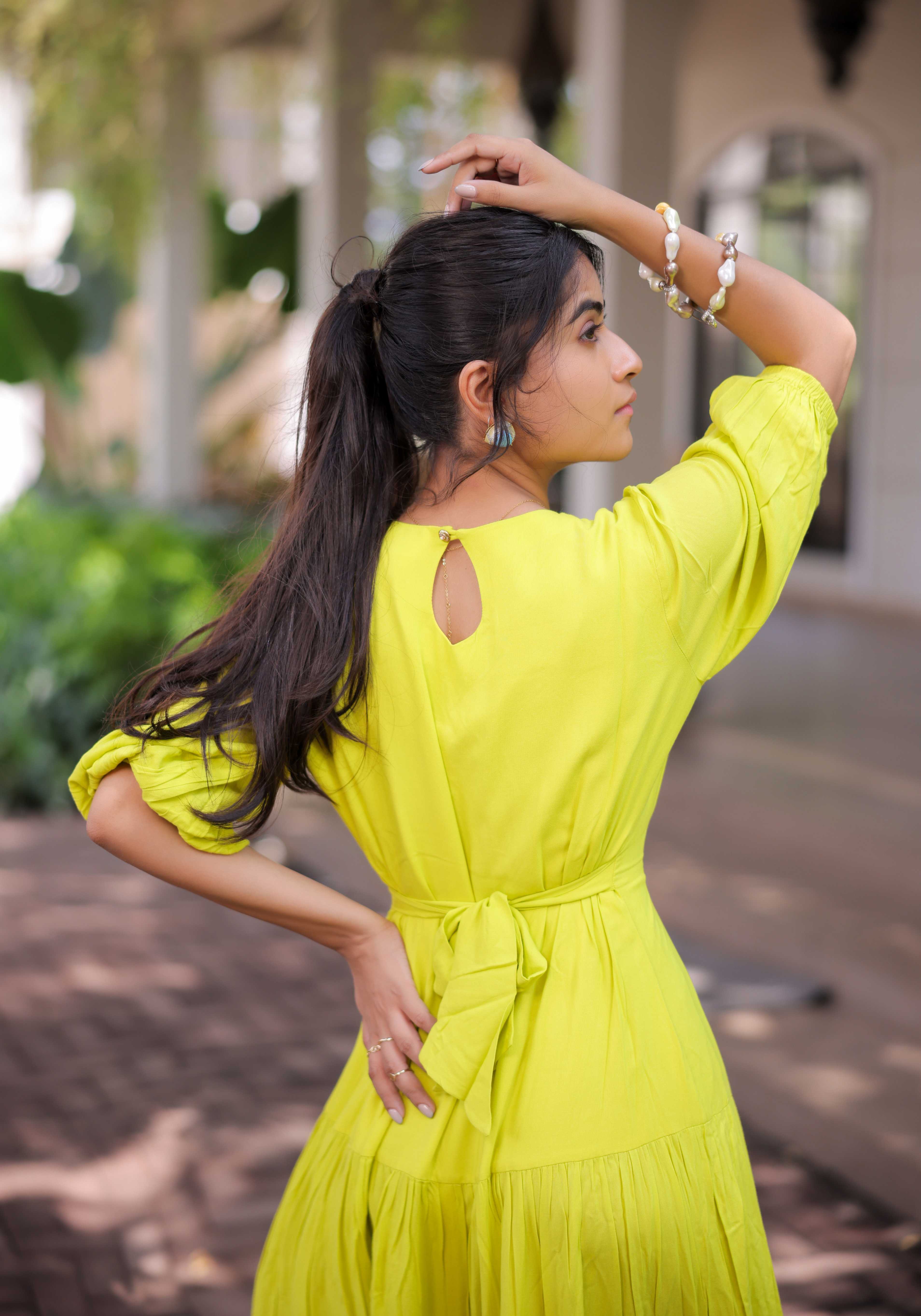 A model showcasing Lime Green Tiered Maxi Dress by Foram Patel from Foram Patel's collection