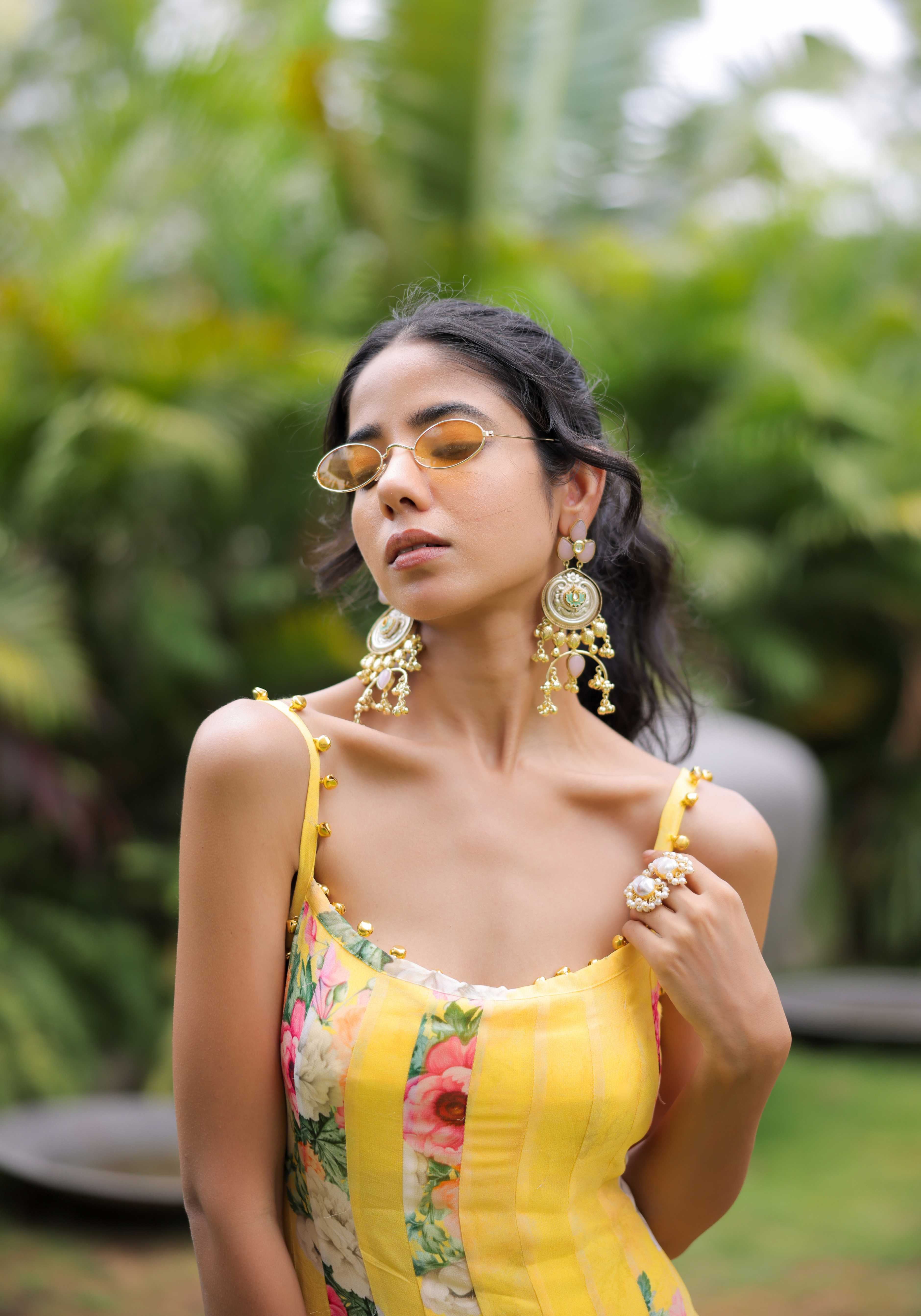 A model showcasing Yellow Floral Printed Pleated Maxi Dress by Foram Patel from Foram Patel's collection