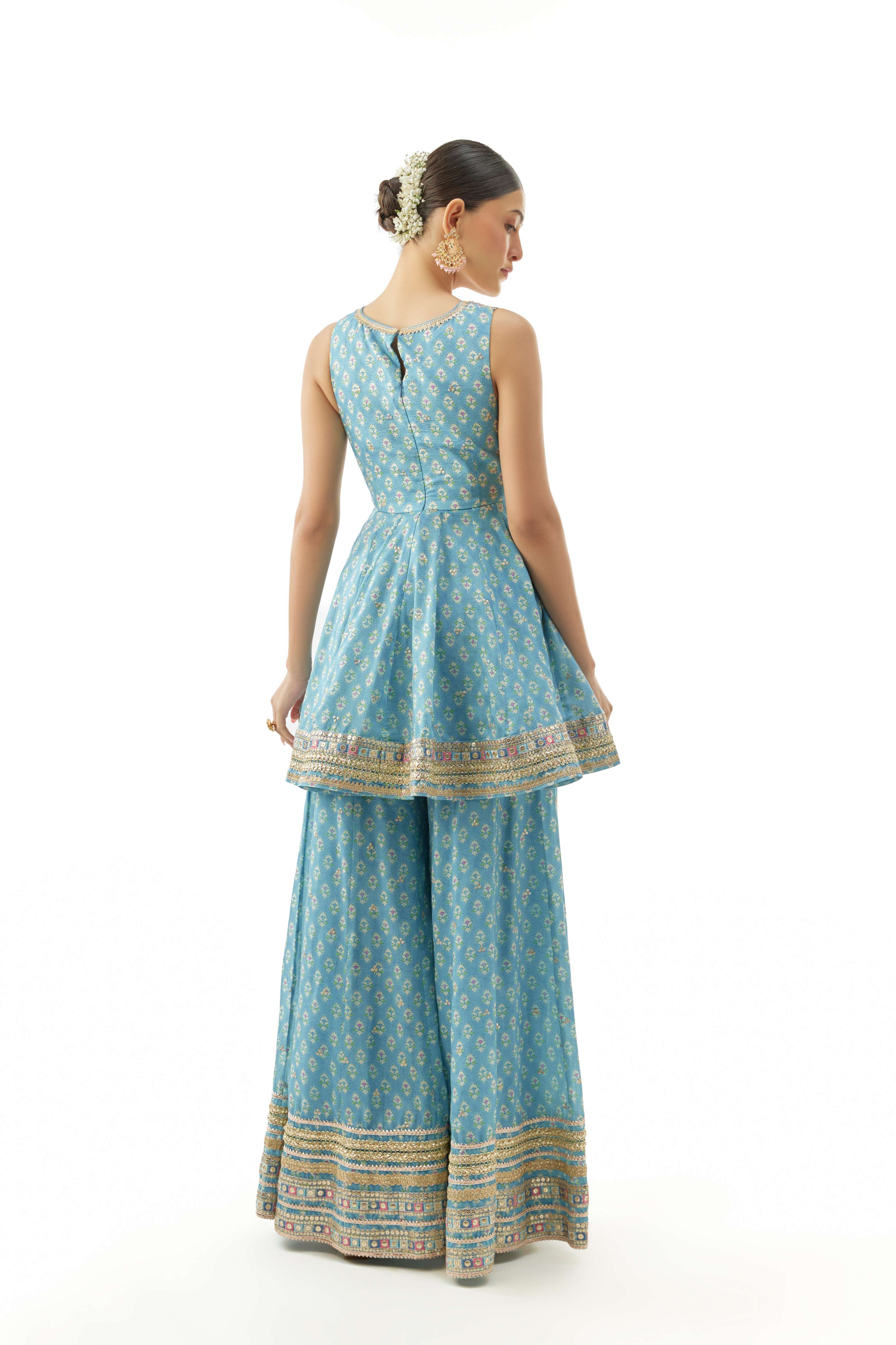 A model showcasing Simoni Blue Peplum Set by Gopi Vaid from Gopi Vaid's collection