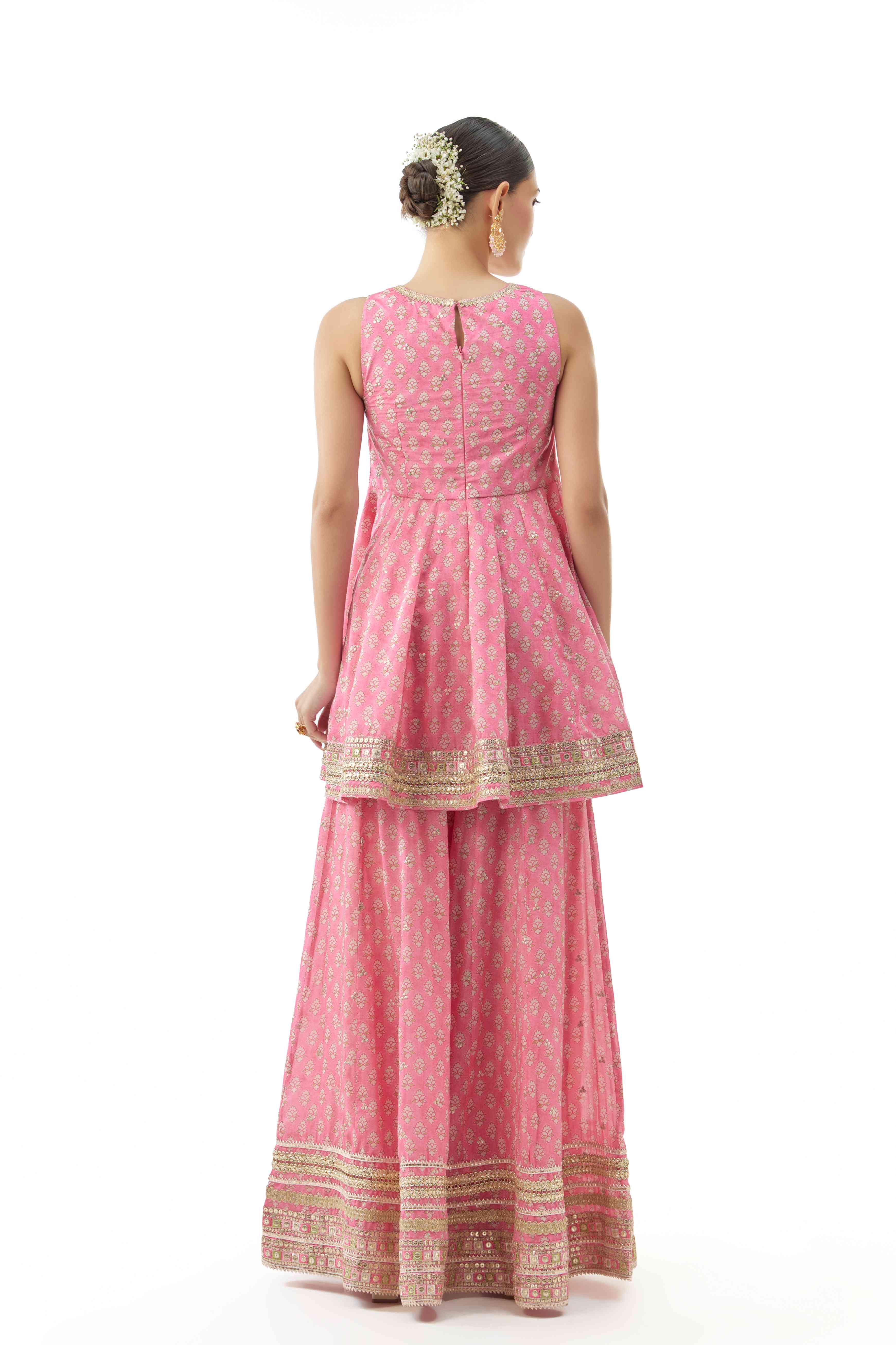 A model showcasing Simoni Pink Peplum Set by Gopi Vaid from Gopi Vaid's collection