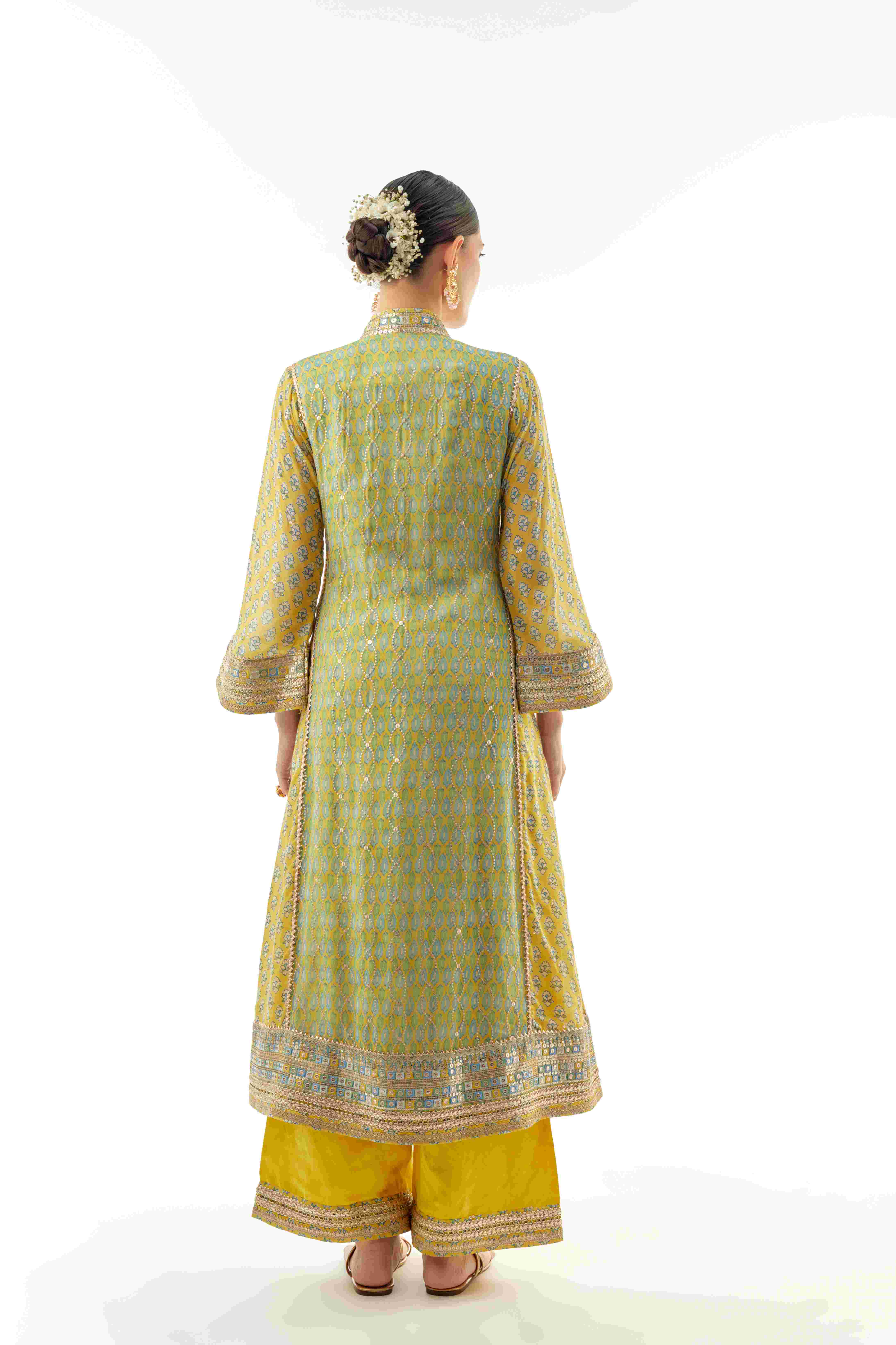 A model showcasing Harshika Yellow Ag Set by Gopi Vaid from Gopi Vaid's collection
