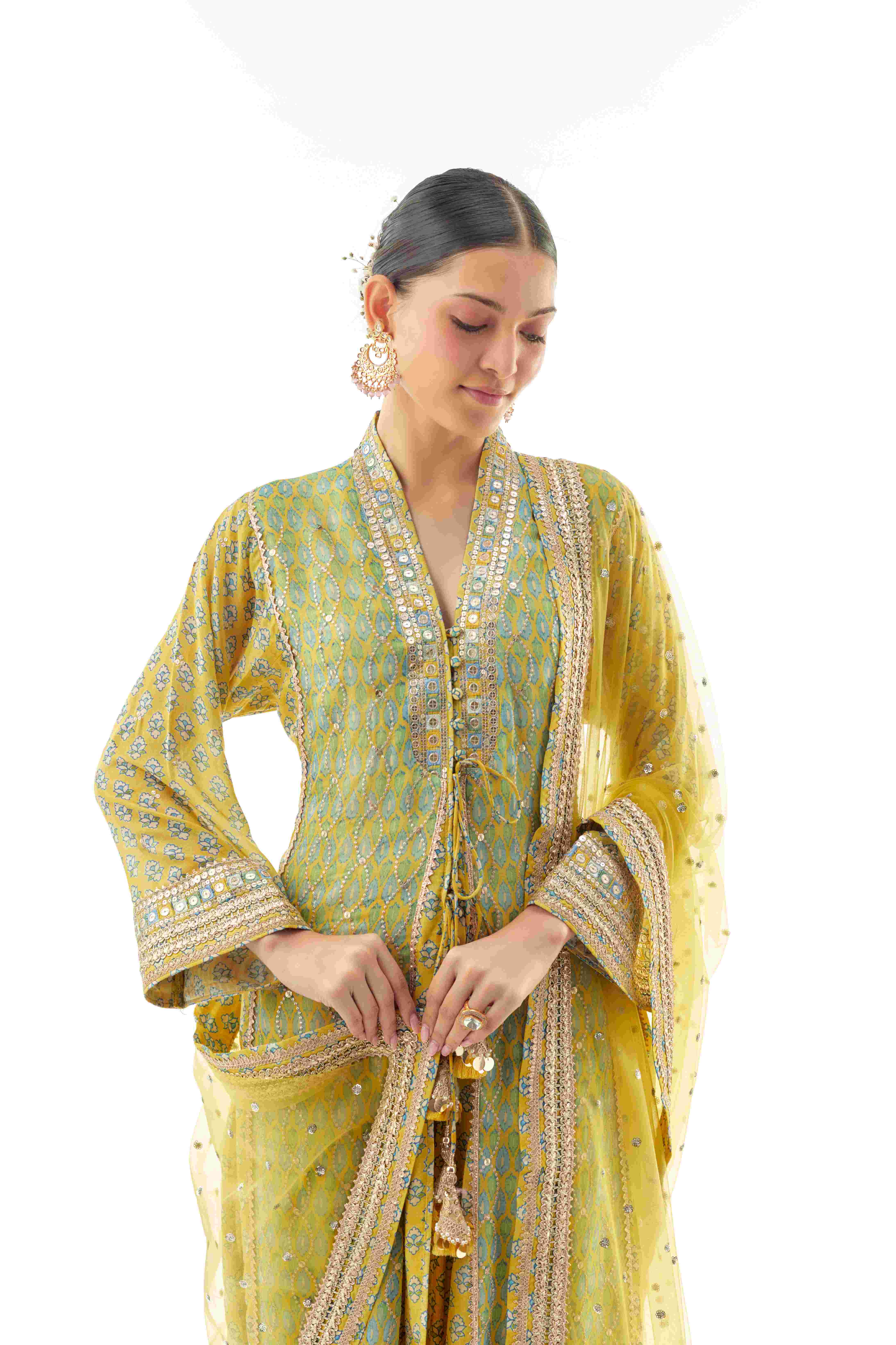 A model showcasing Harshika Yellow Ag Set by Gopi Vaid from Gopi Vaid's collection