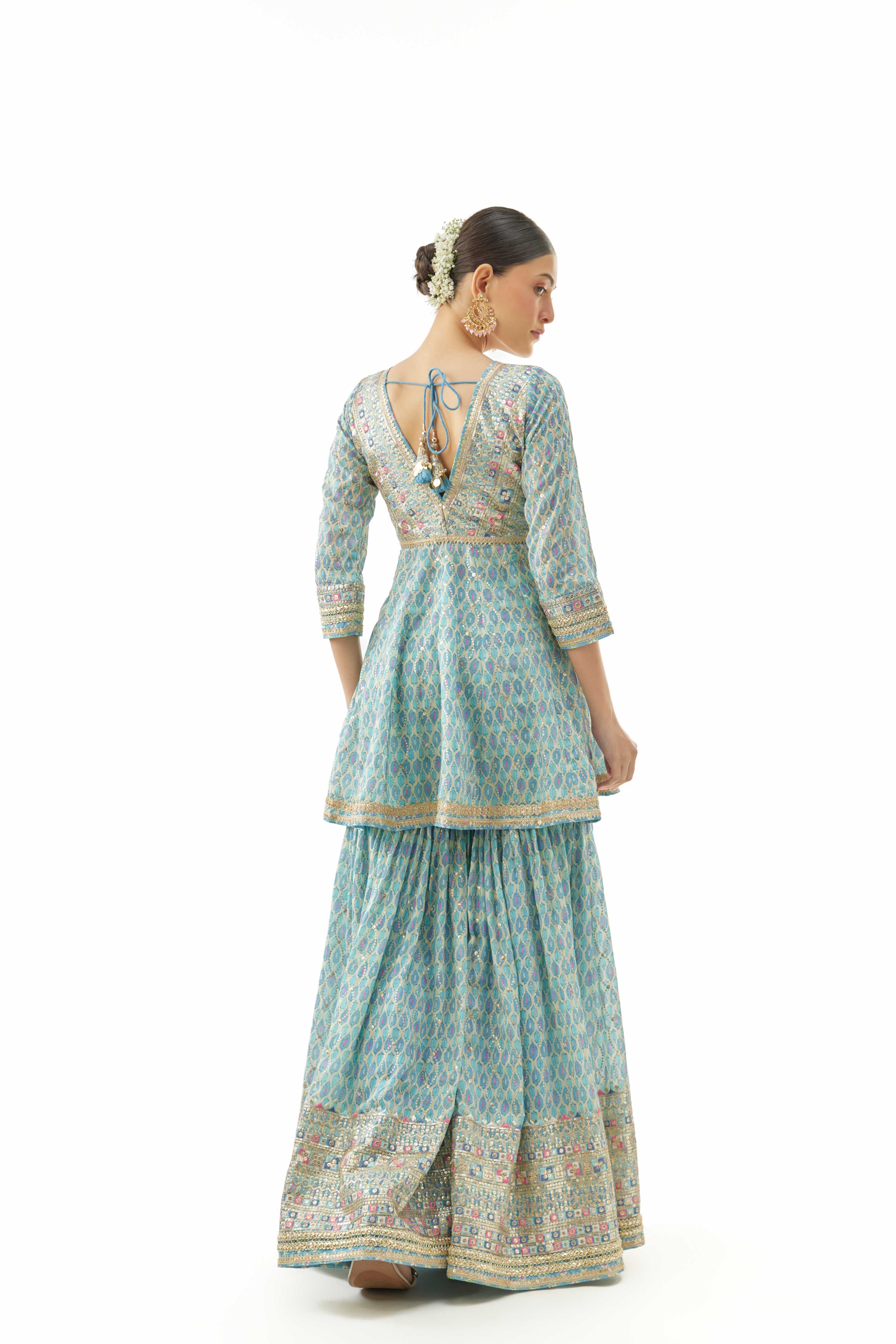 A model showcasing Tanvi Peplum Set by Gopi Vaid from Gopi Vaid's collection A model showcasing Tanvi Peplum Set by Gopi Vaid from Gopi Vaid's collection