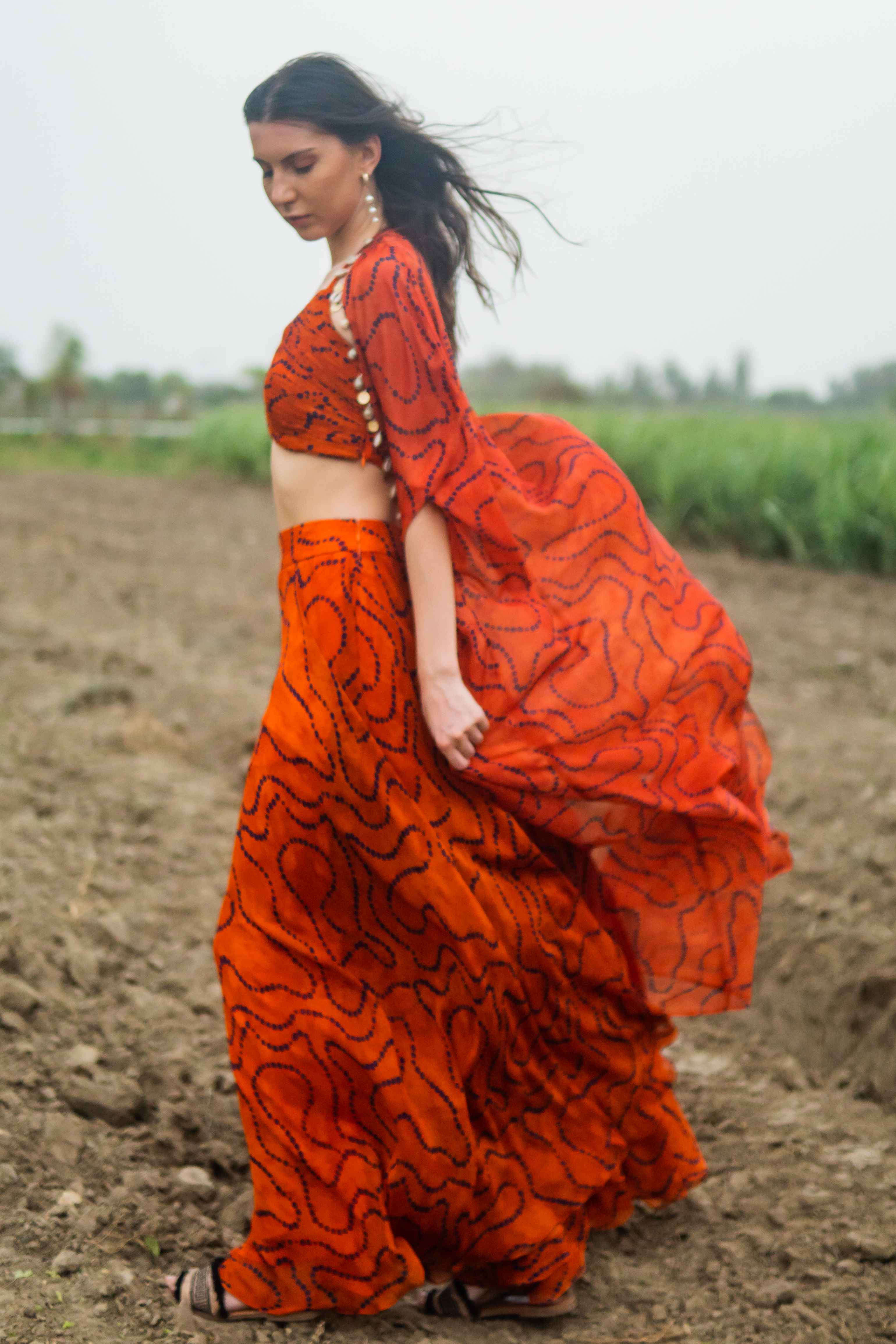A model showcasing Tanjerine Miraze Cape Set by Miku Kumar from Miku Kumar's collection