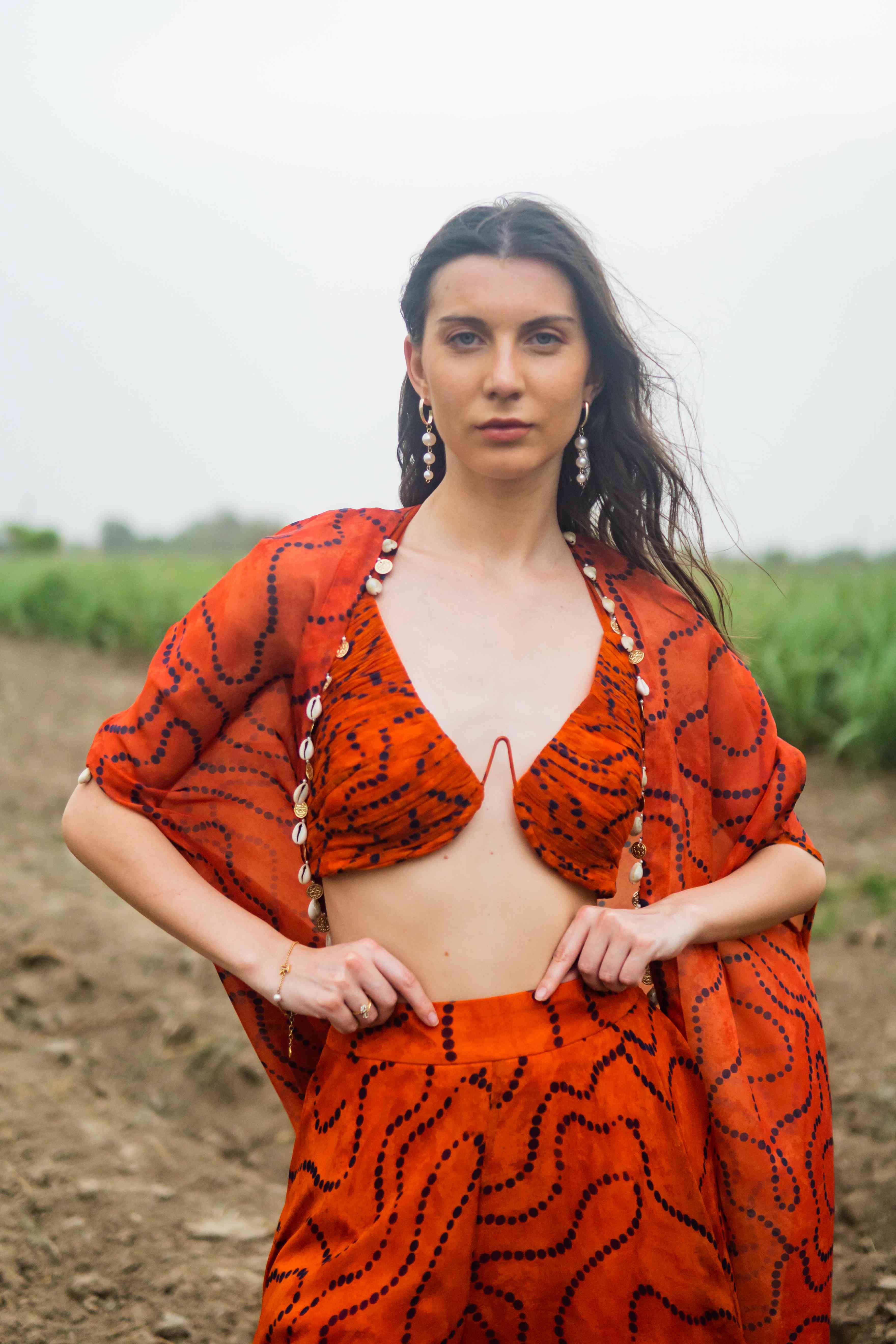 A model showcasing Tanjerine Miraze Cape Set by Miku Kumar from Miku Kumar's collection